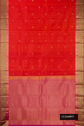 Orange Dual Tone Kanchipuram Silk Saree with Zari Butta on the body and Zari Border.  displayed on a mannequin