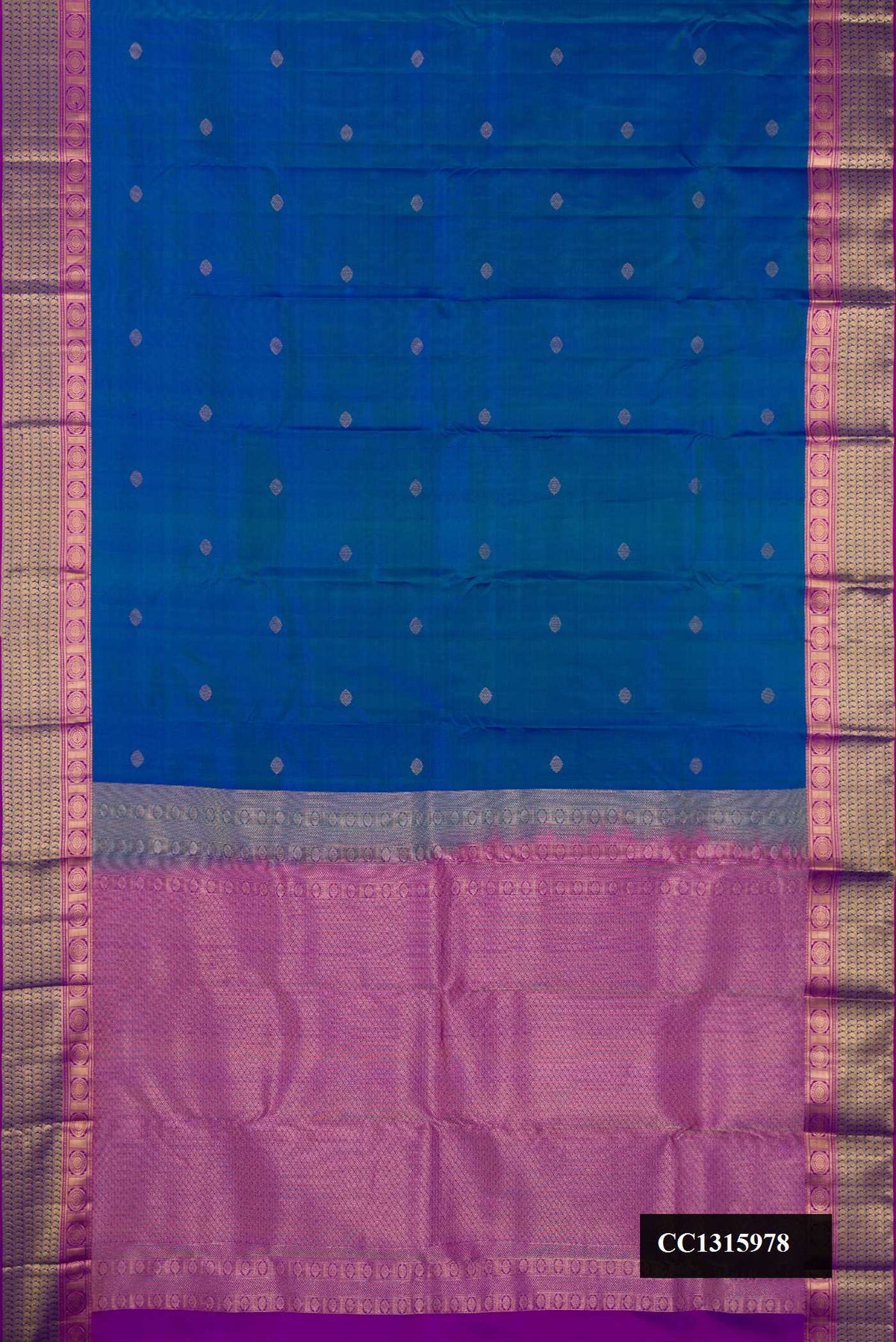 Peacock Blue Dual Tone Kanchipuram Silk Saree with Zari Butta on the body and Zari Border.  displayed on a mannequin