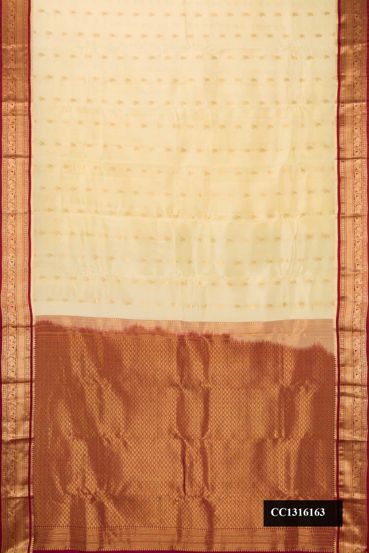 Sandal Dual Tone Kanchipuram Silk Saree with Zari Butta on the body and Zari Border.  displayed on a mannequin