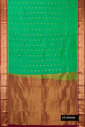 Green Dual Tone Kanchipuram Silk Saree with Zari Butta on the body and Zari Border.  displayed on a mannequin