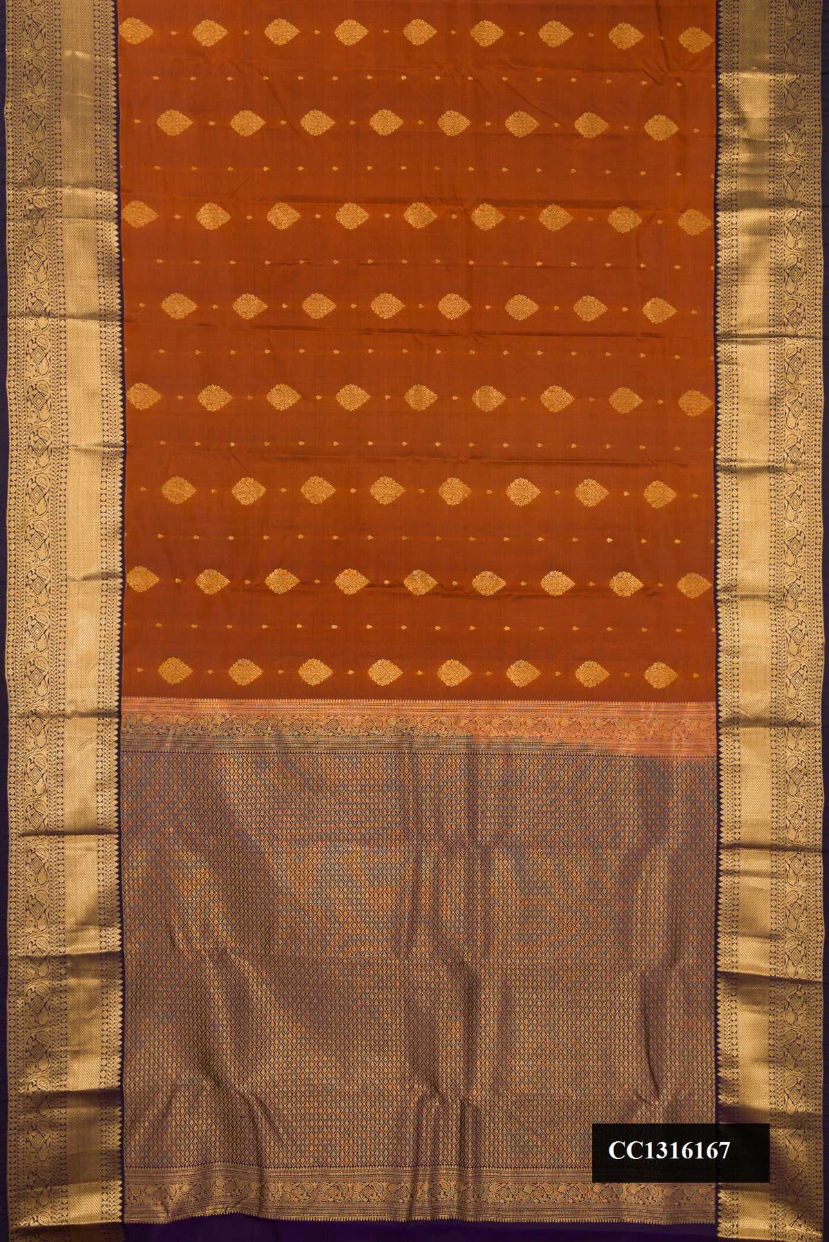 Rust Dual Tone Kanchipuram Silk Saree with Zari Butta on the body and Zari Border.  displayed on a mannequin