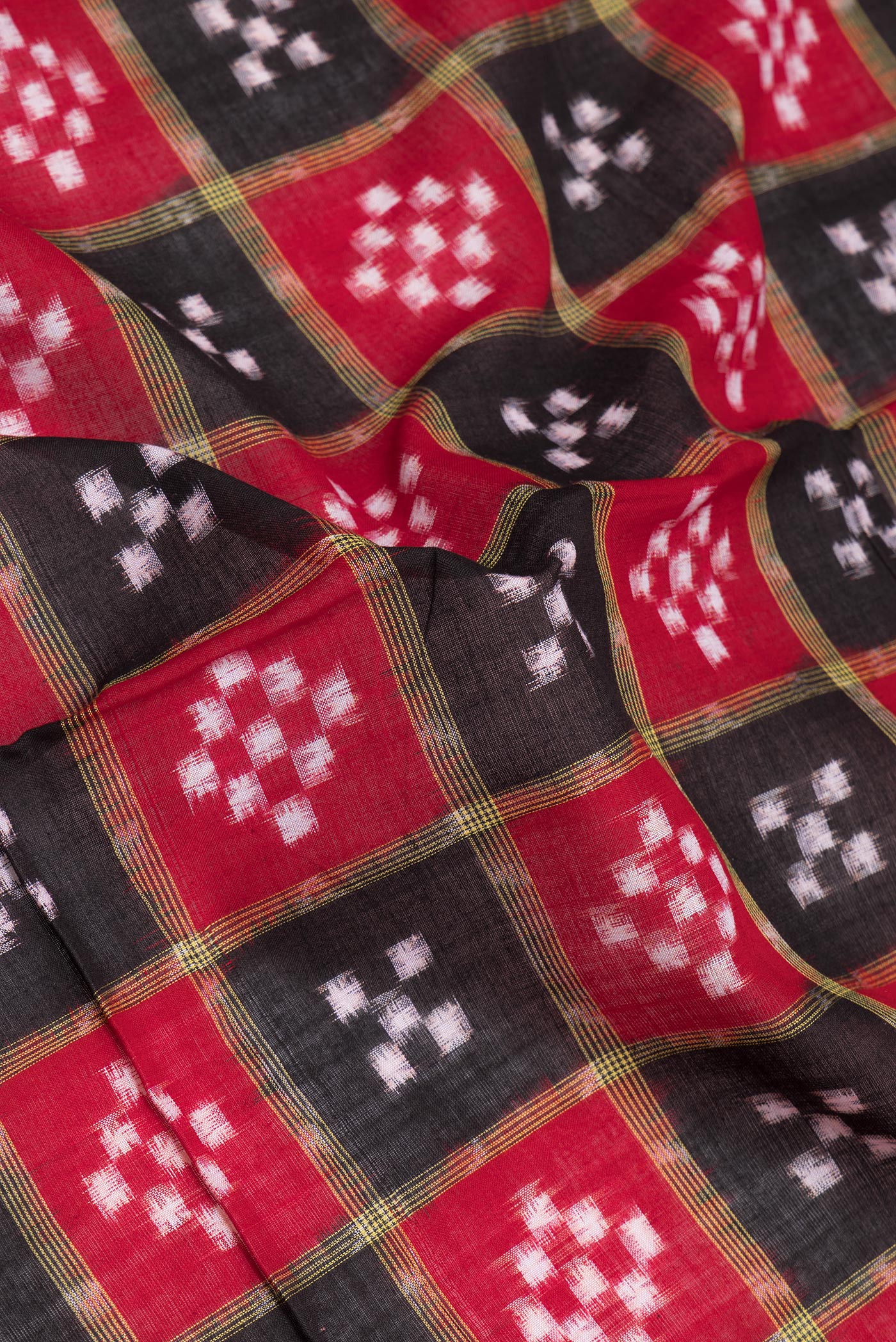 Close up of Black Pochampally Cotton Saree with Ikat design on the body and Thread Border.  displaying folds