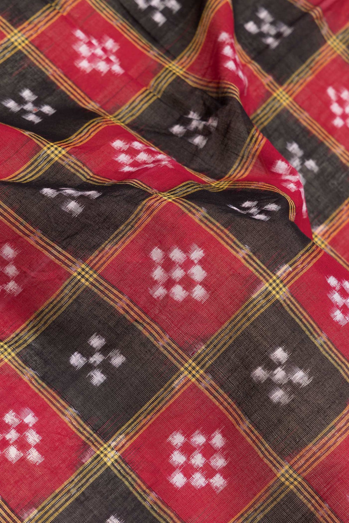 Close up of Black and Maroon Color Double Ikat Saree with Ikat Print on the body and Thread Border.  displaying folds