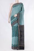 Green Dual Tone Double Ikat Saree with Ikat Print on the body and Ikat Border displayed on a mannequin