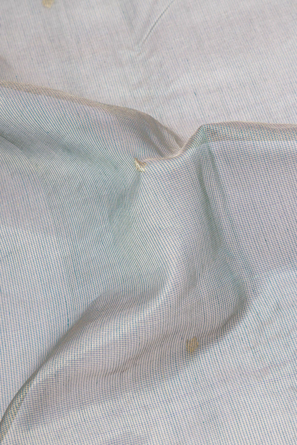 Close up of Grey Kota Silk Saree with Checked design on the body and Zari Border.  displaying folds