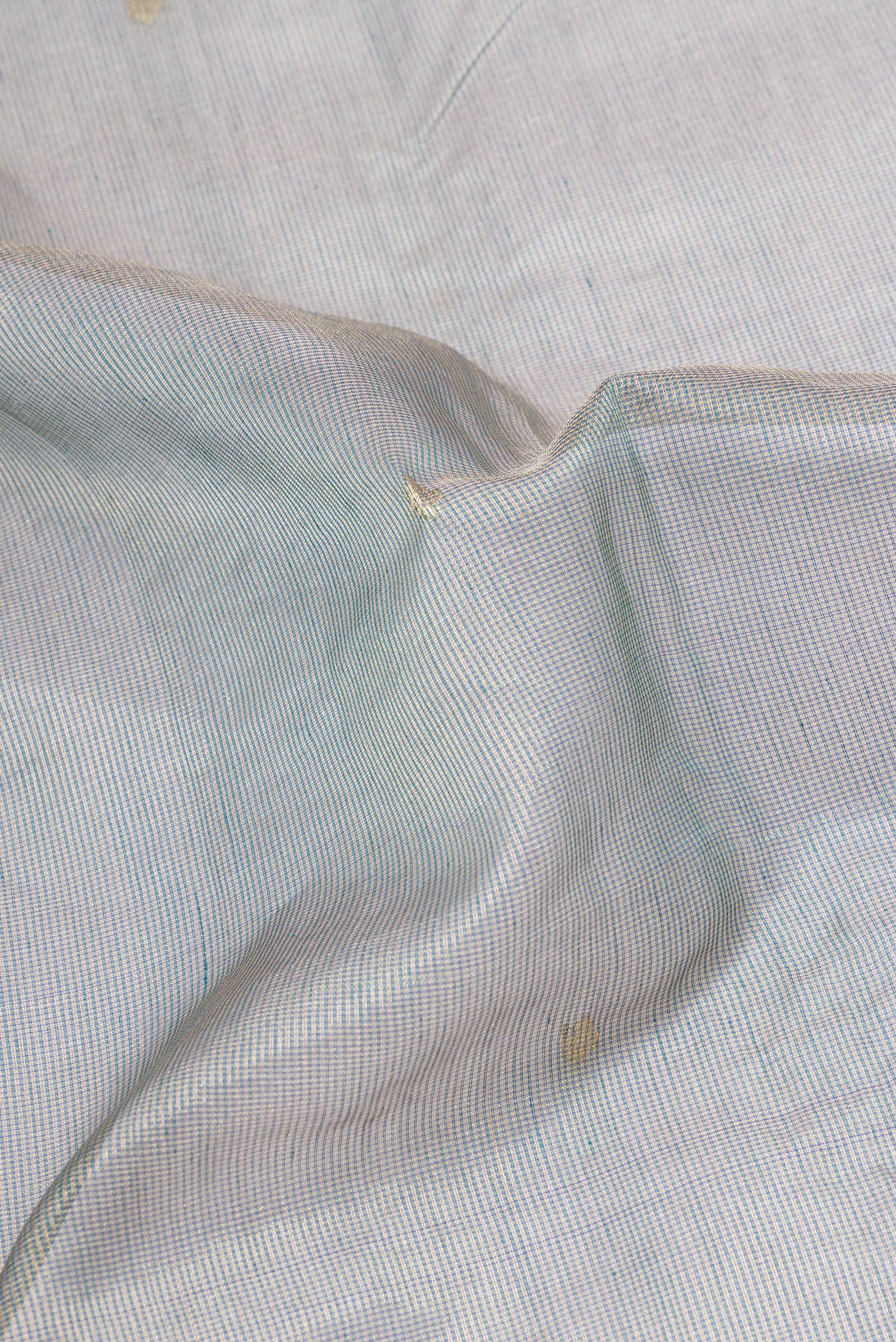 Close up of Grey Kota Silk Saree with Checked design on the body and Zari Border.  displaying folds
