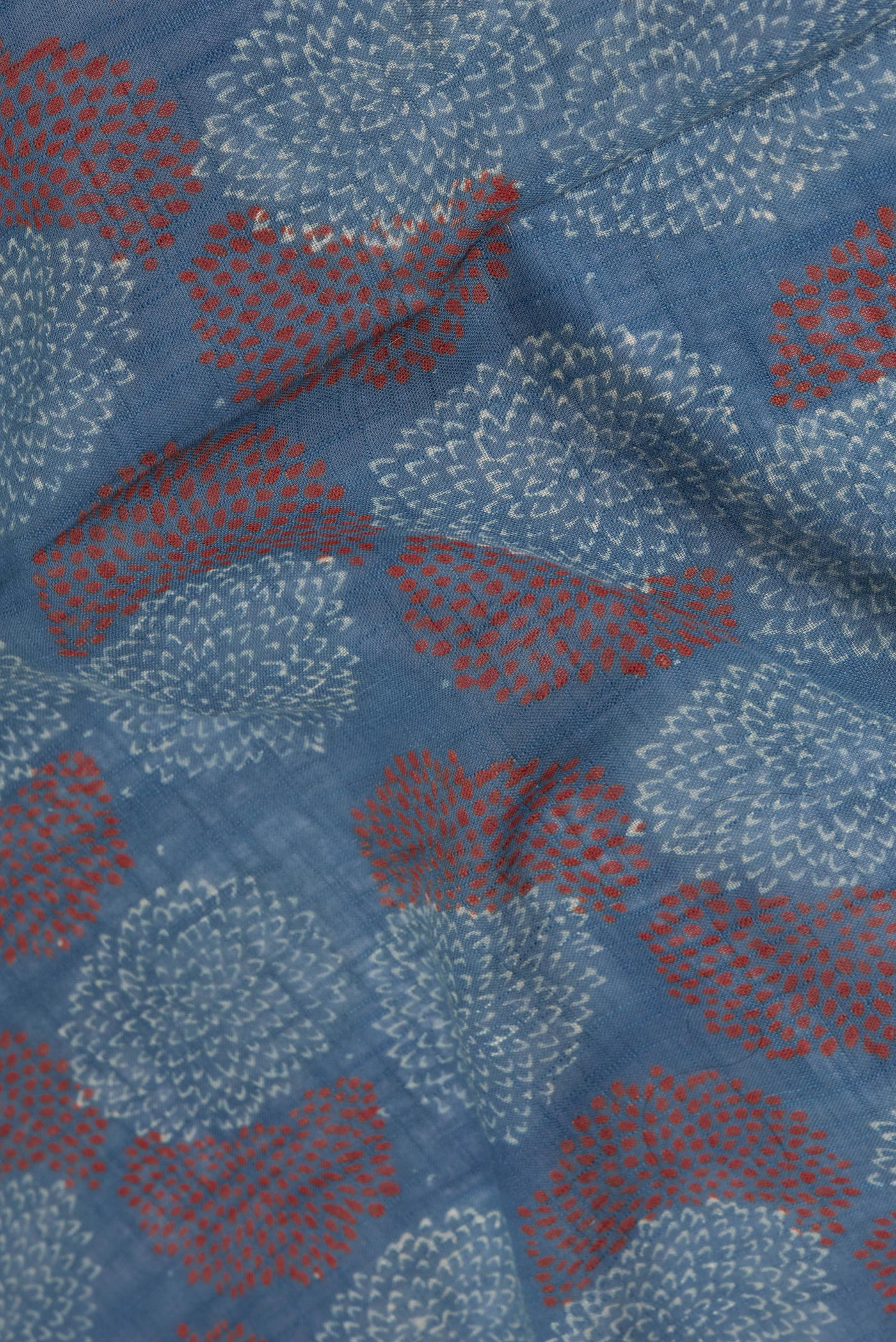 Close up of Blue Linen Saree with Ajrakh Print on the body and Zari Border.  displaying folds
