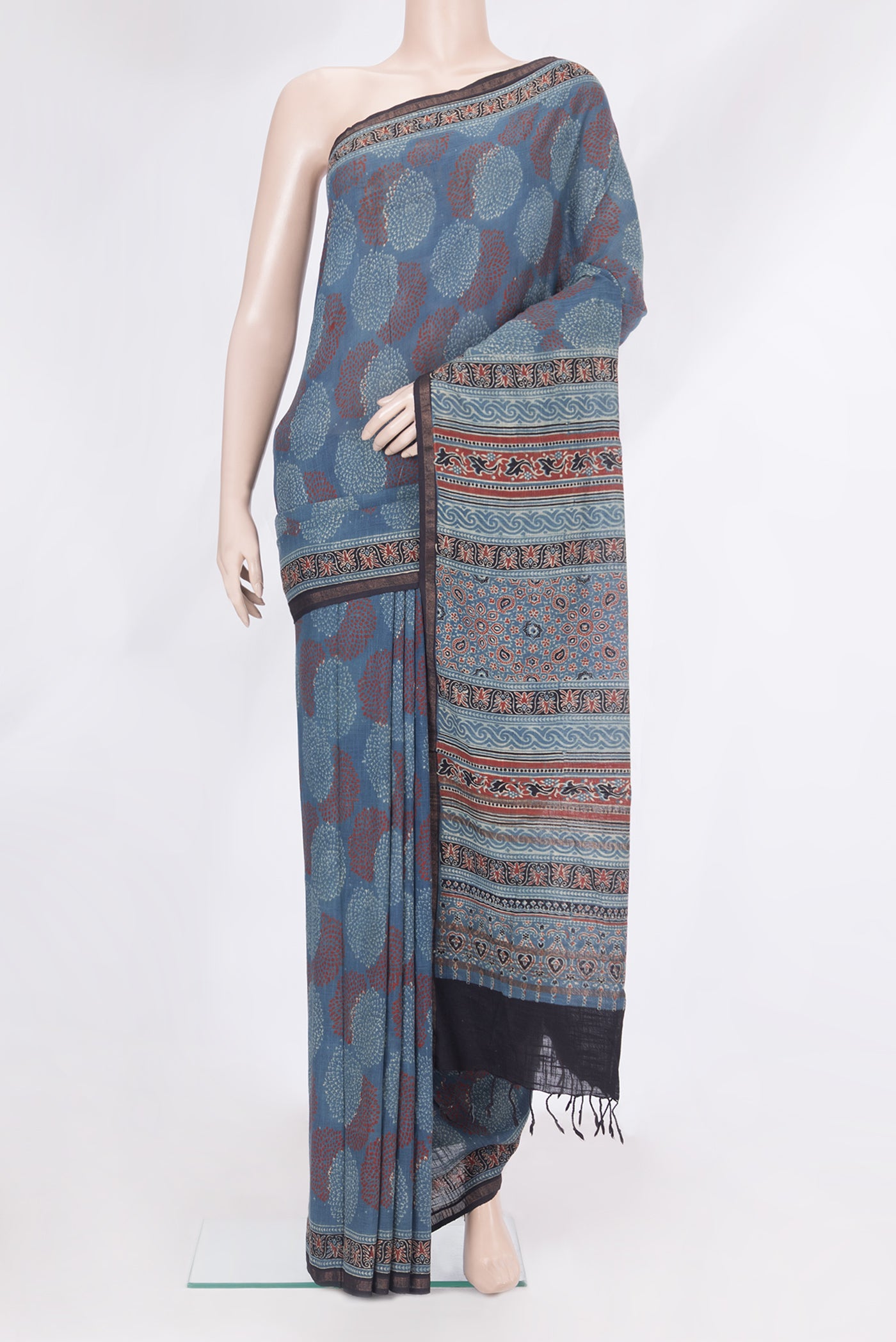 Blue Linen Saree with Ajrakh Print on the body and Zari Border.  displayed on a mannequin