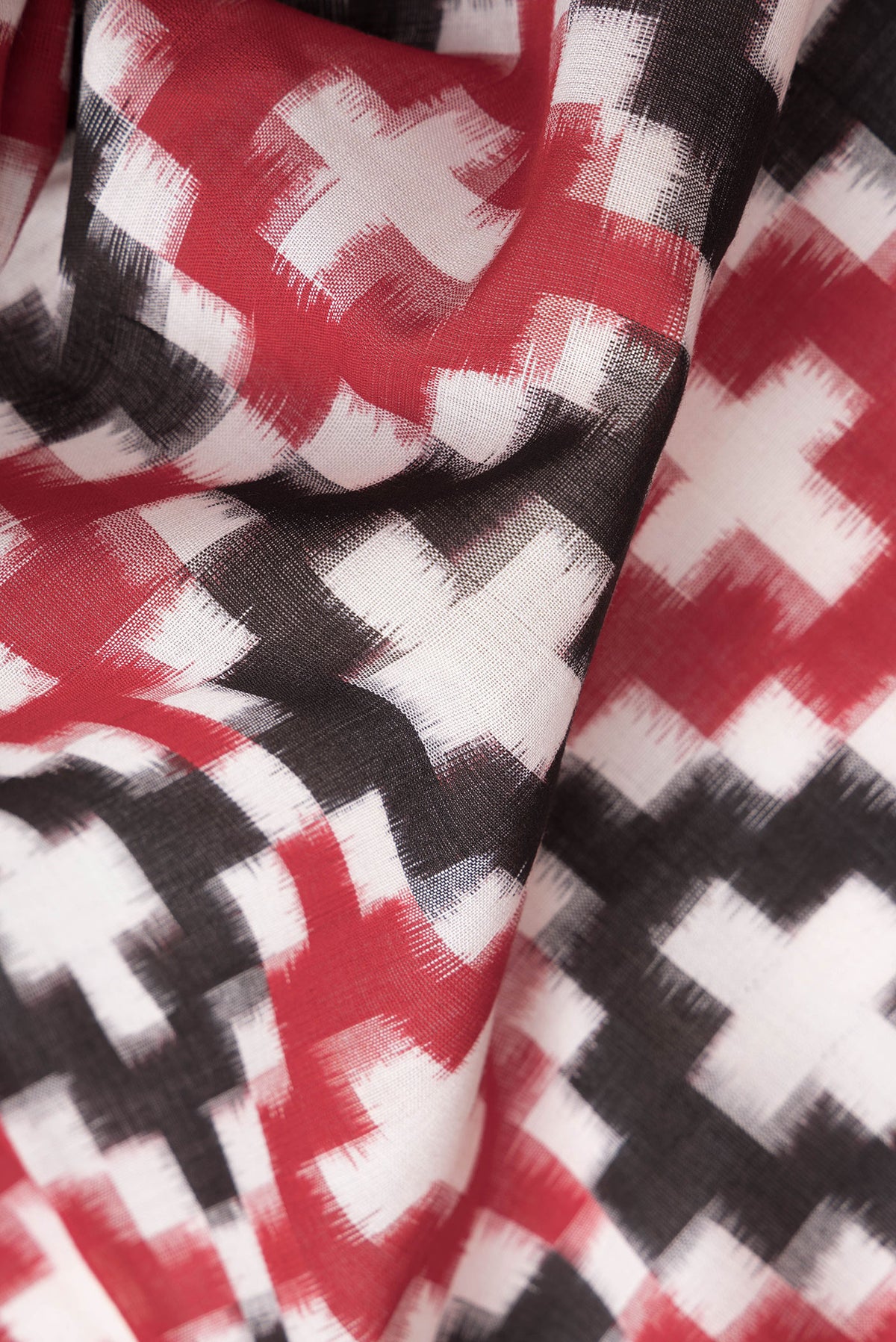 Close up of Black and Maroon Color Double Ikat Saree with Ikat Print on the body and Plain Border.  displaying folds