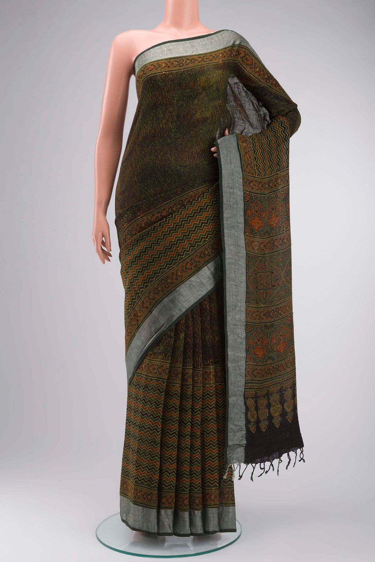 Green Linen Saree with Printed design on the body and Zari Border displayed on a mannequin