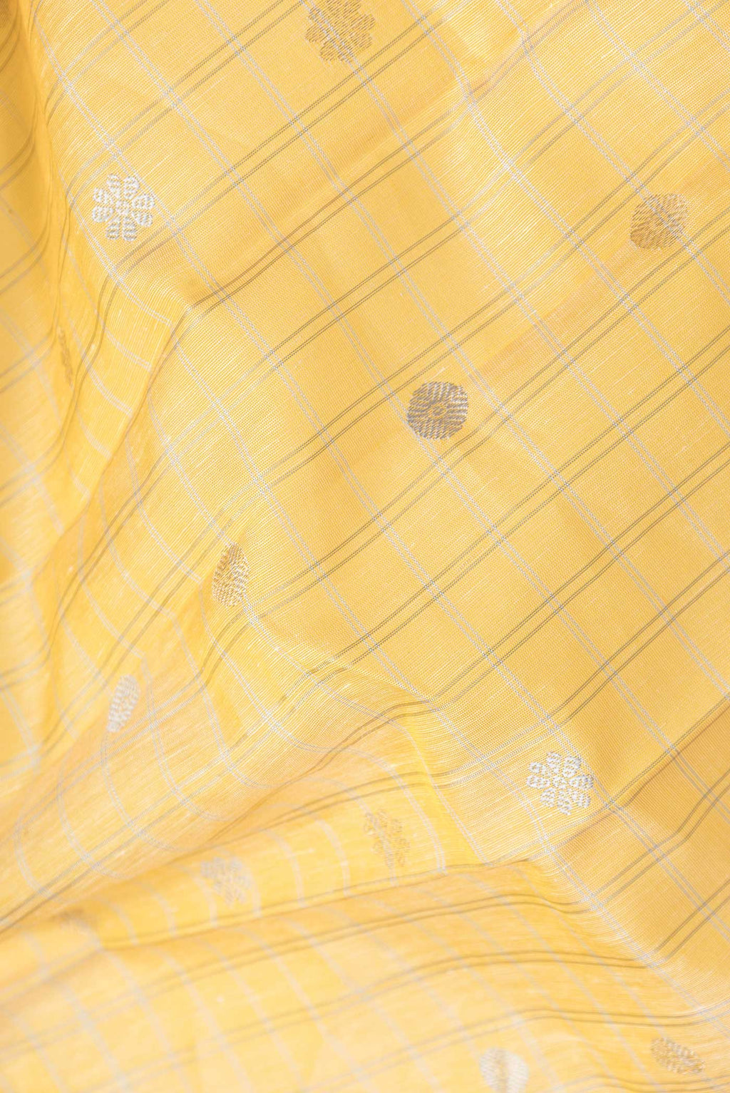 Close up of Lemon Yellow Dual Tone Linen Saree with Checked design on the body and Zari Border.  displaying folds
