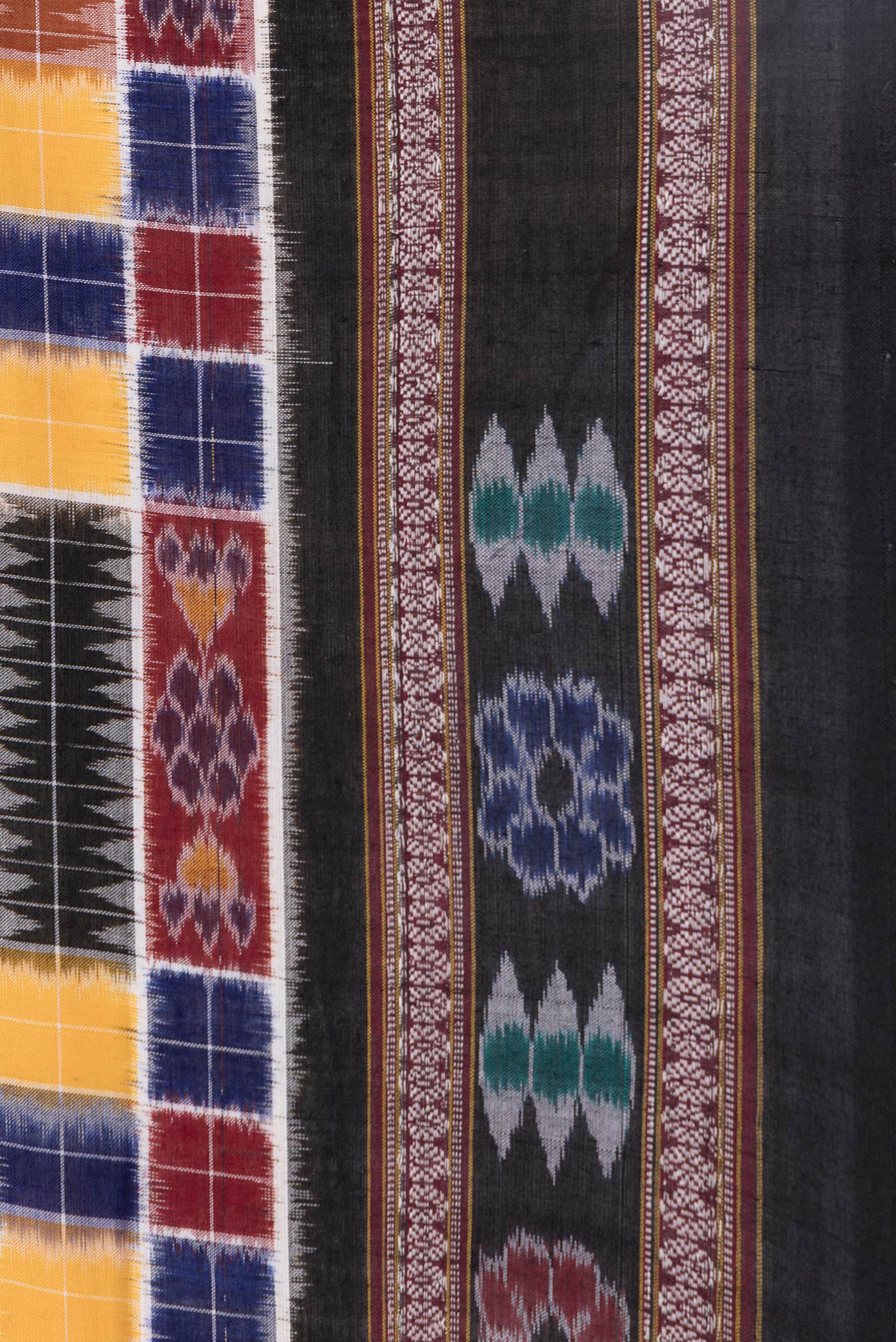 Border image of Black and Maroon Color Double Ikat Saree with Ikat Print on the body and Thread Border. 