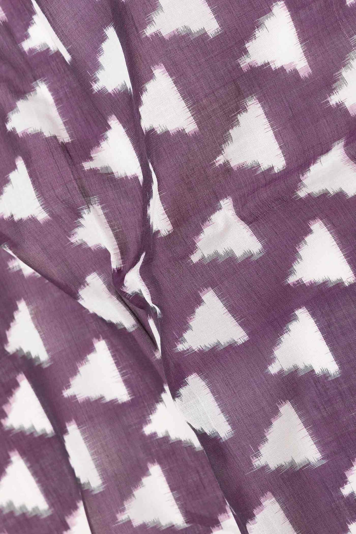 Close up of Burgundy Dual Tone Double Ikat Saree with Ikat Print on the body and Plain Border displaying folds
