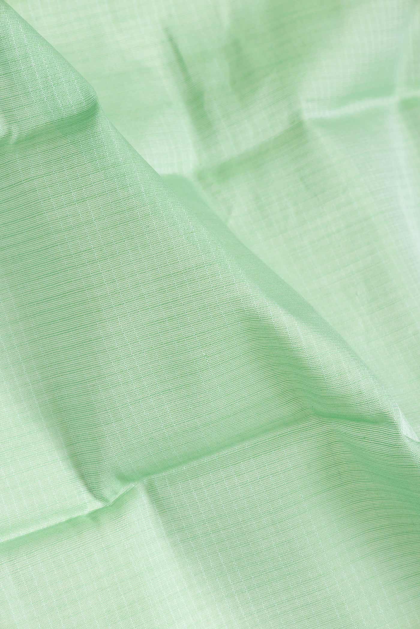 Close up of Pista Green Dual Tone Gadwal Silk Saree with Checked design on the body and Zari Border.  displaying folds