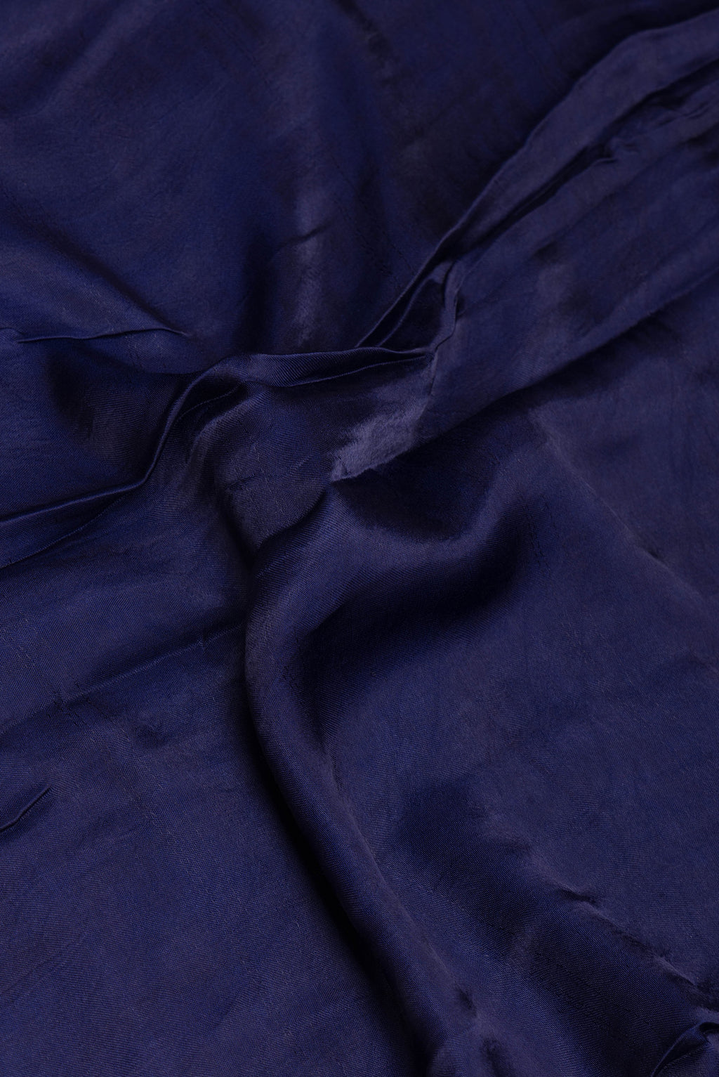 Close up of Blue Blended Satin Crepe Saree with Printed design on the body and Printed Border.  displaying folds