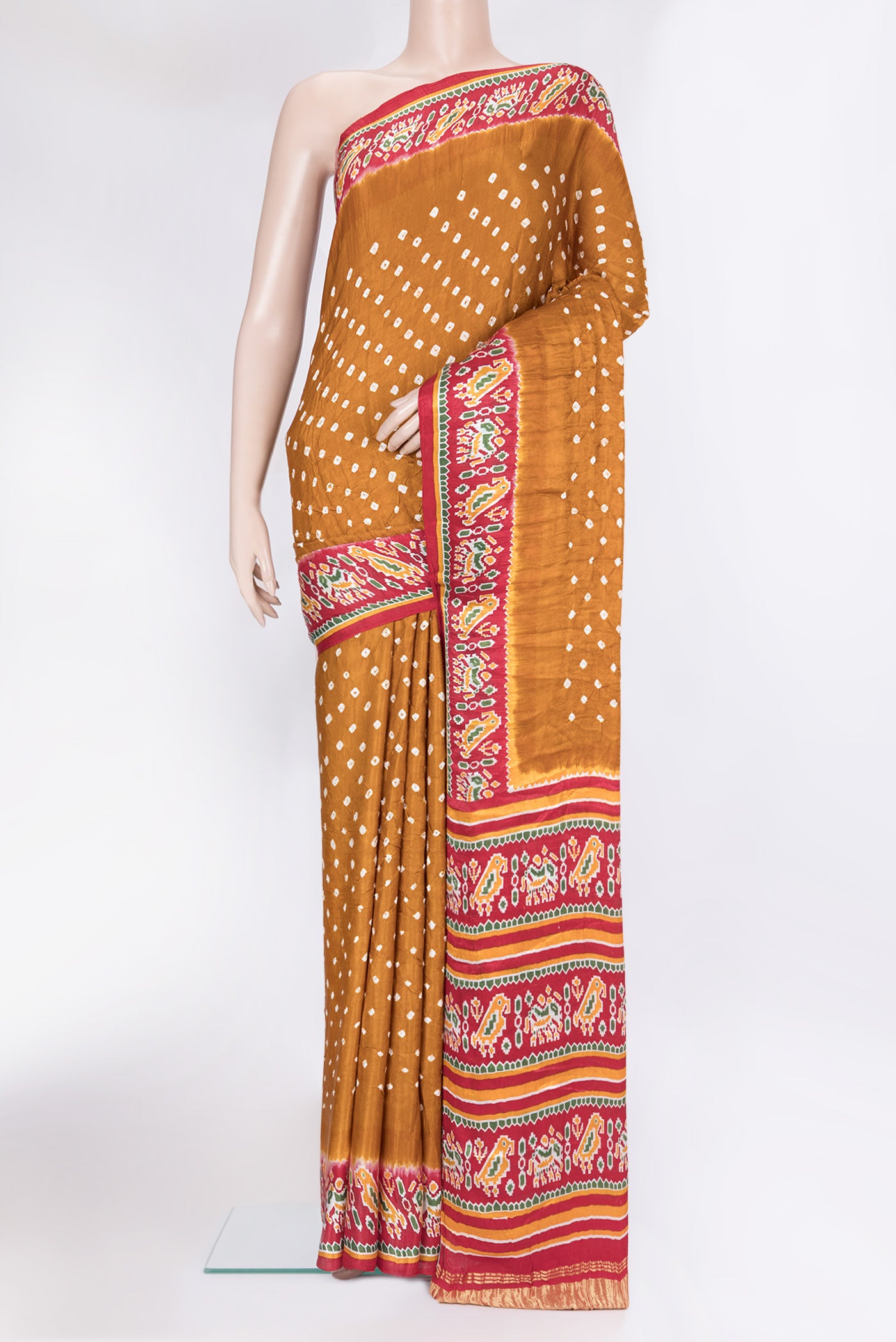 Mustard Blended Satin Crepe Saree with Bandhani Print on the body and Printed Border.  displayed on a mannequin