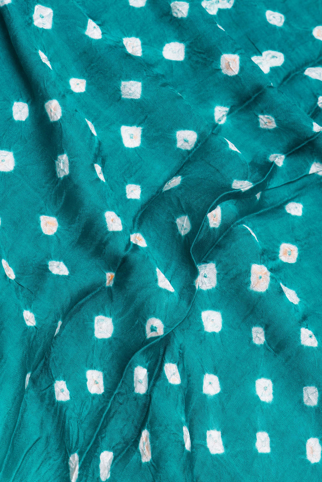 Close up of Blue Blended Satin Crepe Saree with Bandhani Print on the body and Printed Border.  displaying folds