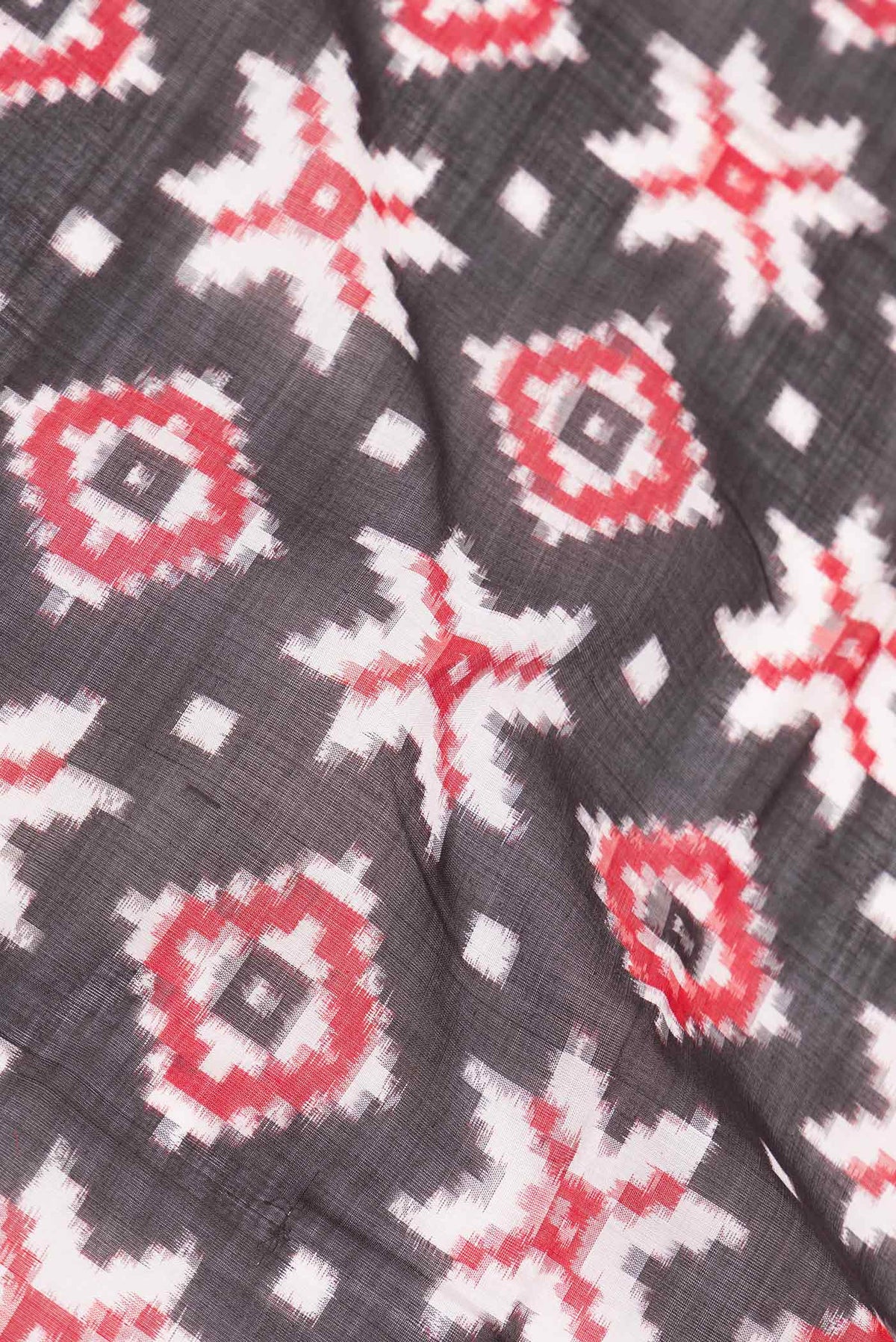 Close up of Black Dual Tone Double Ikat Saree with Ikat Print on the body and Plain Border displaying folds