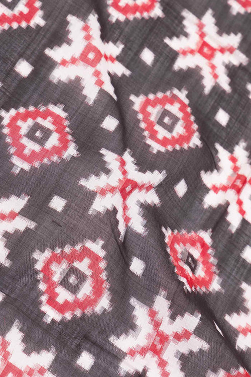 Close up of Black Dual Tone Double Ikat Saree with Ikat Print on the body and Plain Border displaying folds