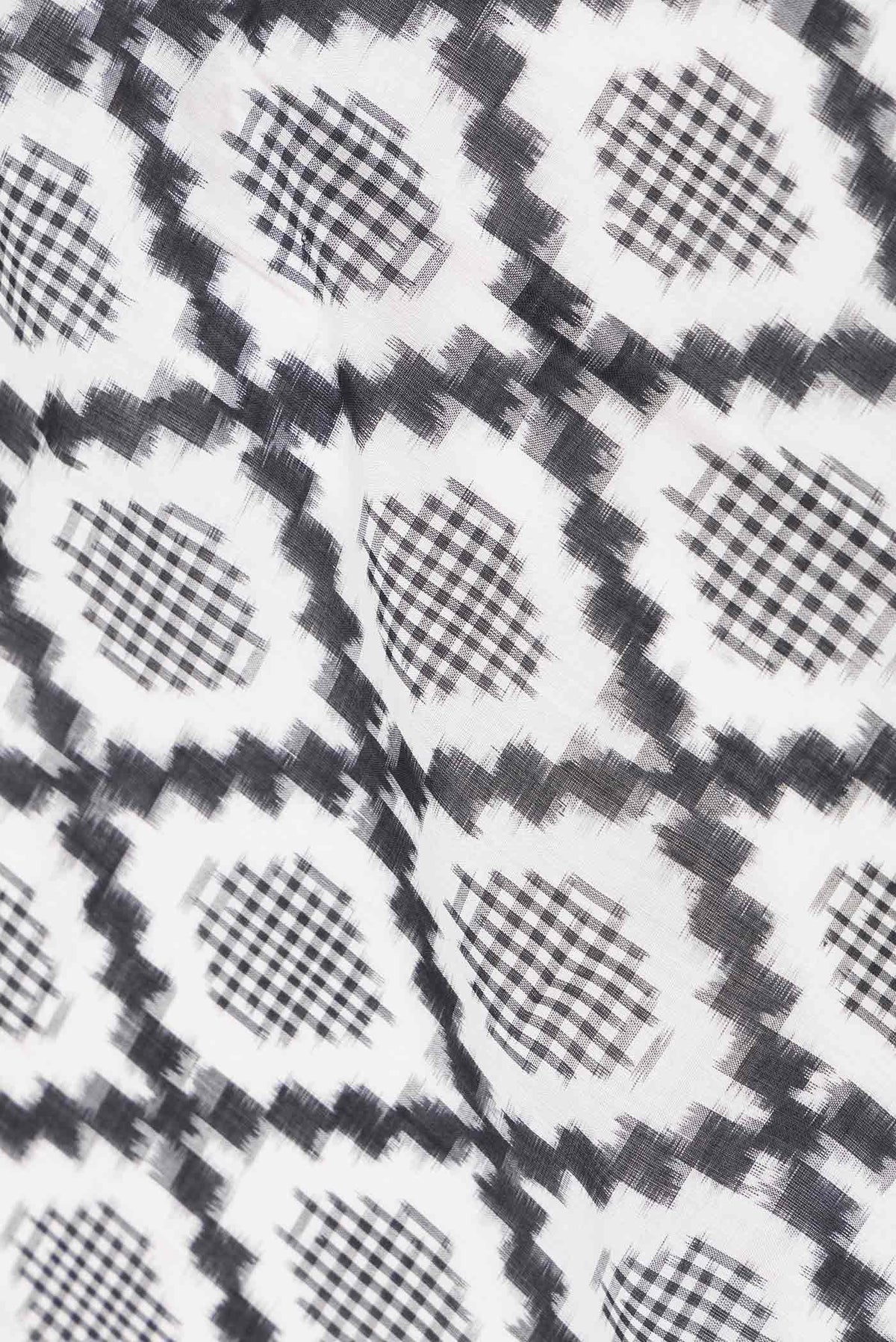 Close up of Off White Dual Tone Double Ikat Saree with Ikat Print on the body and Plain Border displaying folds