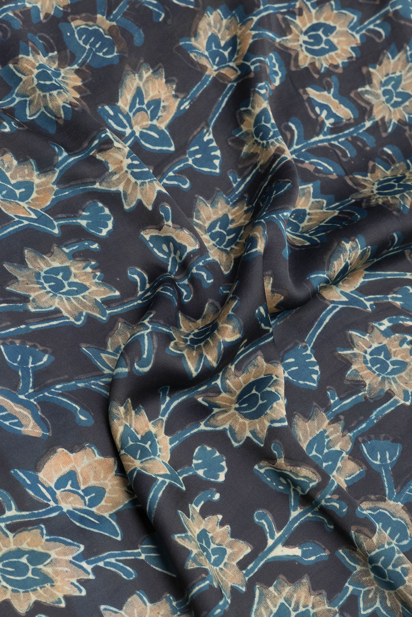 Close up of Black Blended Satin Crepe Saree with Printed design on the body and Printed Border.  displaying folds