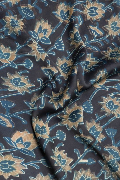 Close up of Black Blended Satin Crepe Saree with Printed design on the body and Printed Border.  displaying folds
