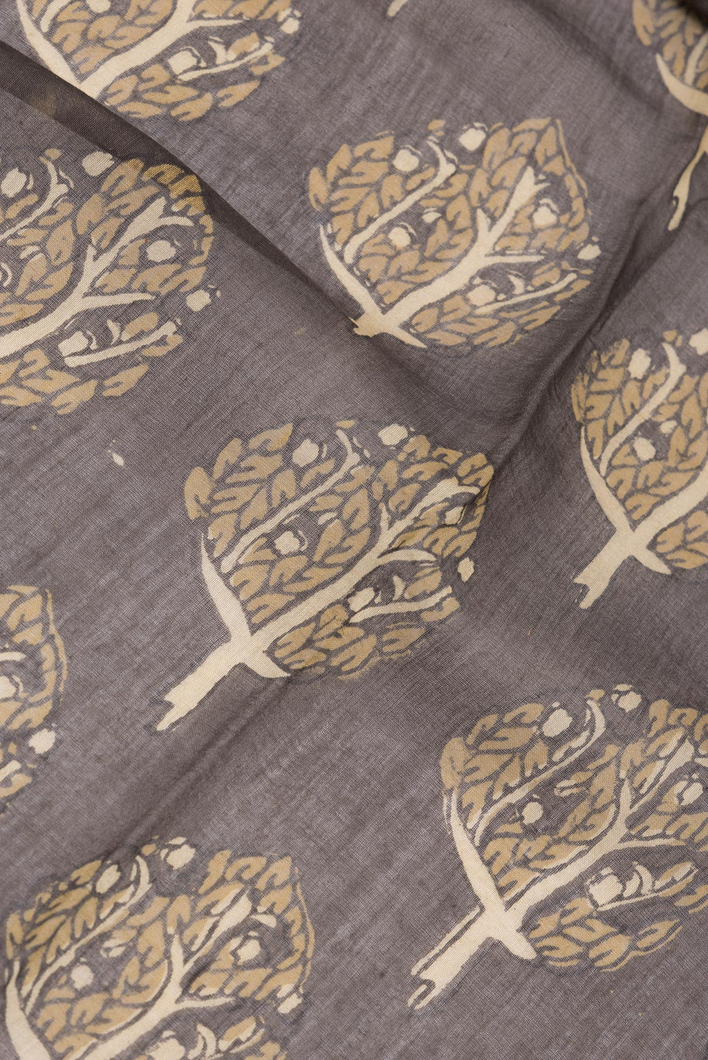 Close up of Brown Chanderi Silk Cotton Saree with Printed design on the body and Zari Border.  displaying folds