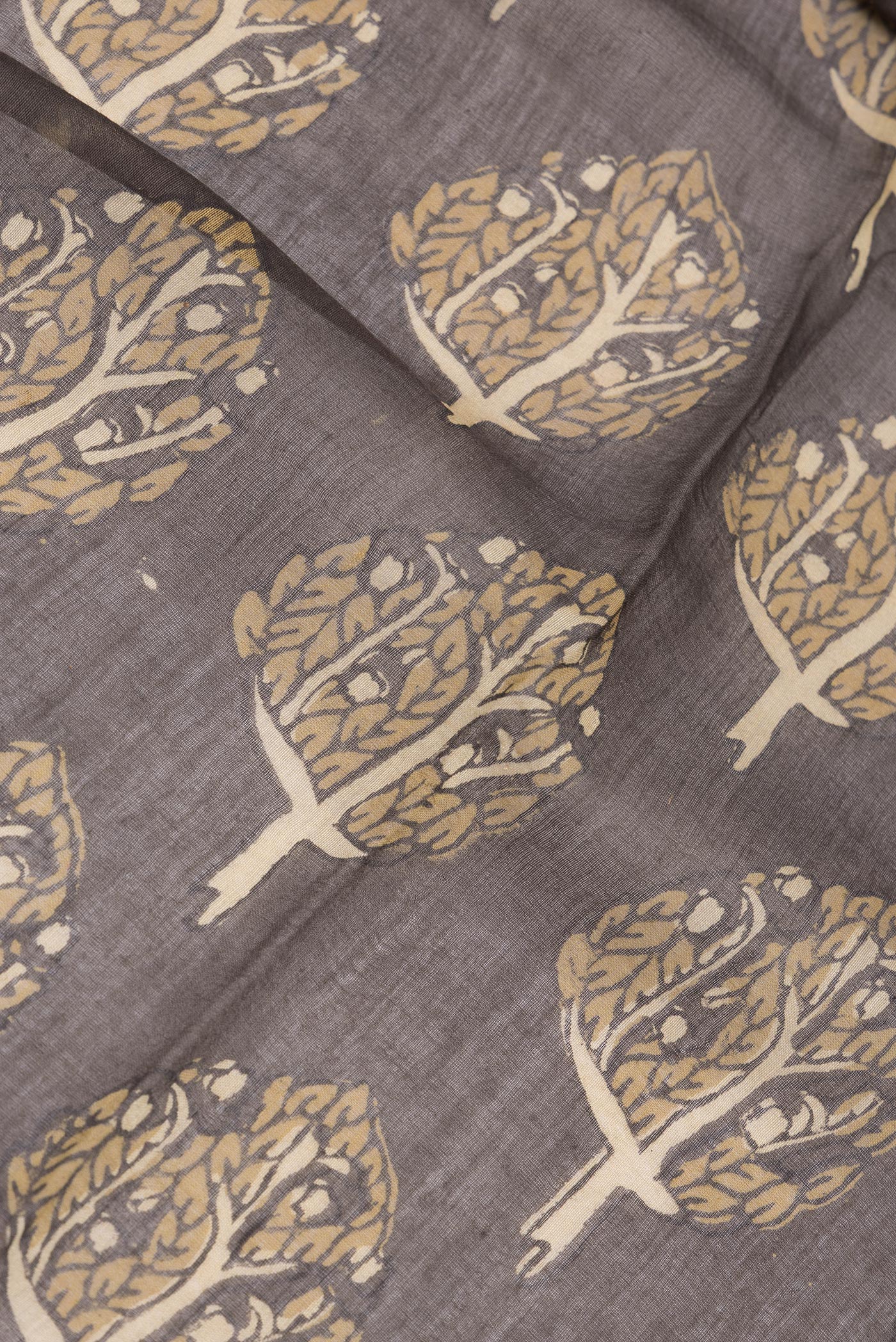 Close up of Brown Chanderi Silk Cotton Saree with Printed design on the body and Zari Border.  displaying folds
