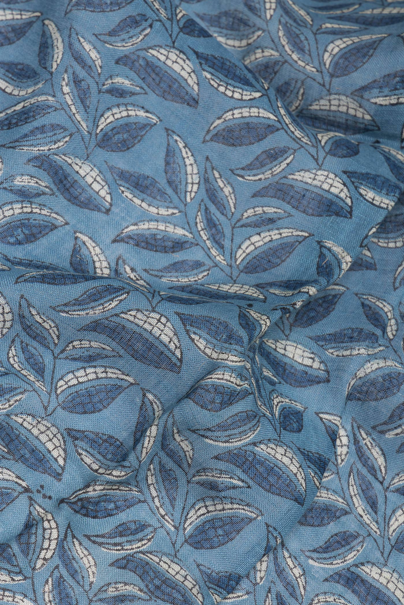 Close up of Blue Grey Linen Saree with Ajrakh Print on the body and Zari Border.  displaying folds