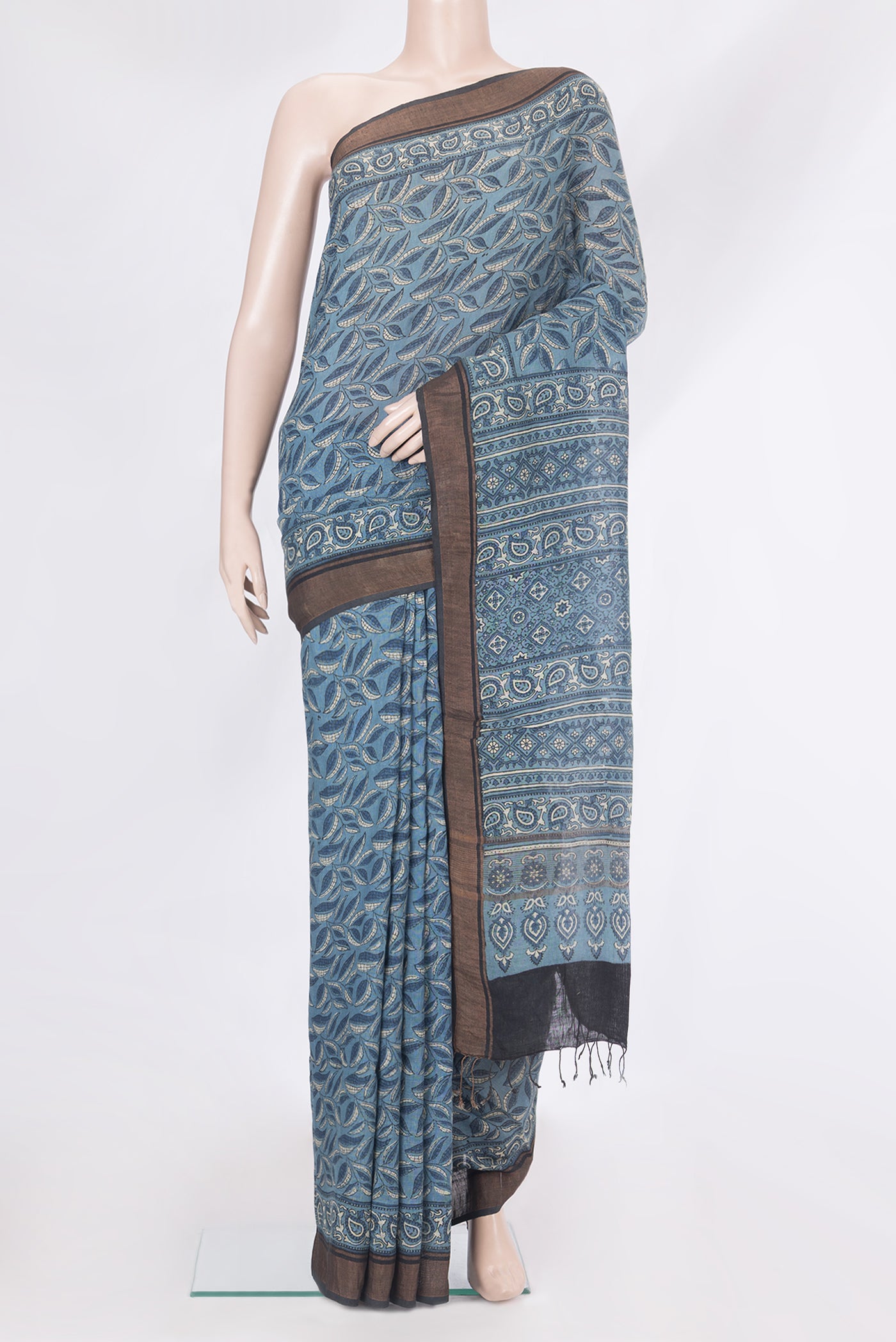 Blue Grey Linen Saree with Ajrakh Print on the body and Zari Border.  displayed on a mannequin