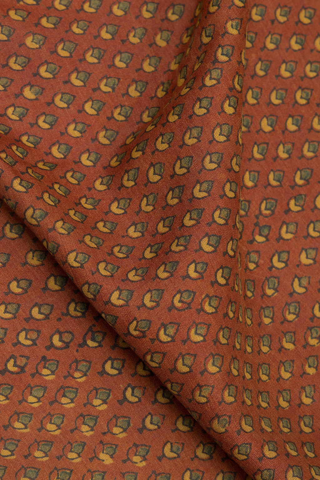 Close up of Pure Silk Maroon Dual Tone Tussar Saree with Printed design on the body and Zari Border.  displaying folds