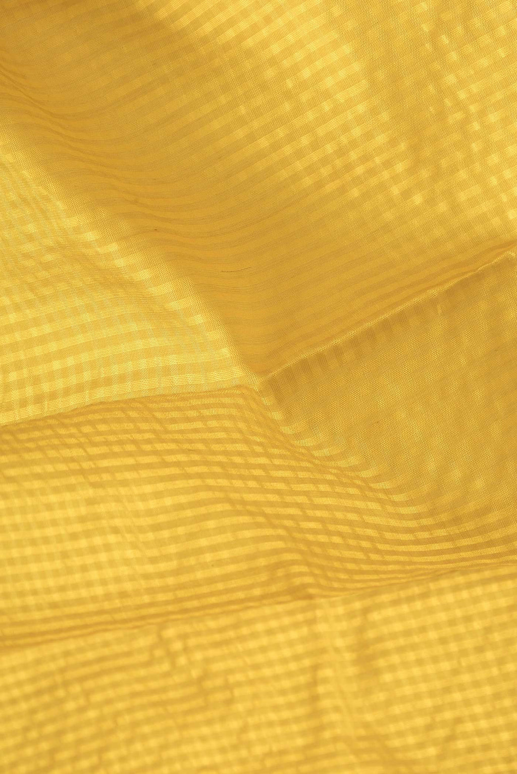 Close up of Yellow Dual Tone Gadwal Silk Saree with Checked design on the body and Thread Border.  displaying folds