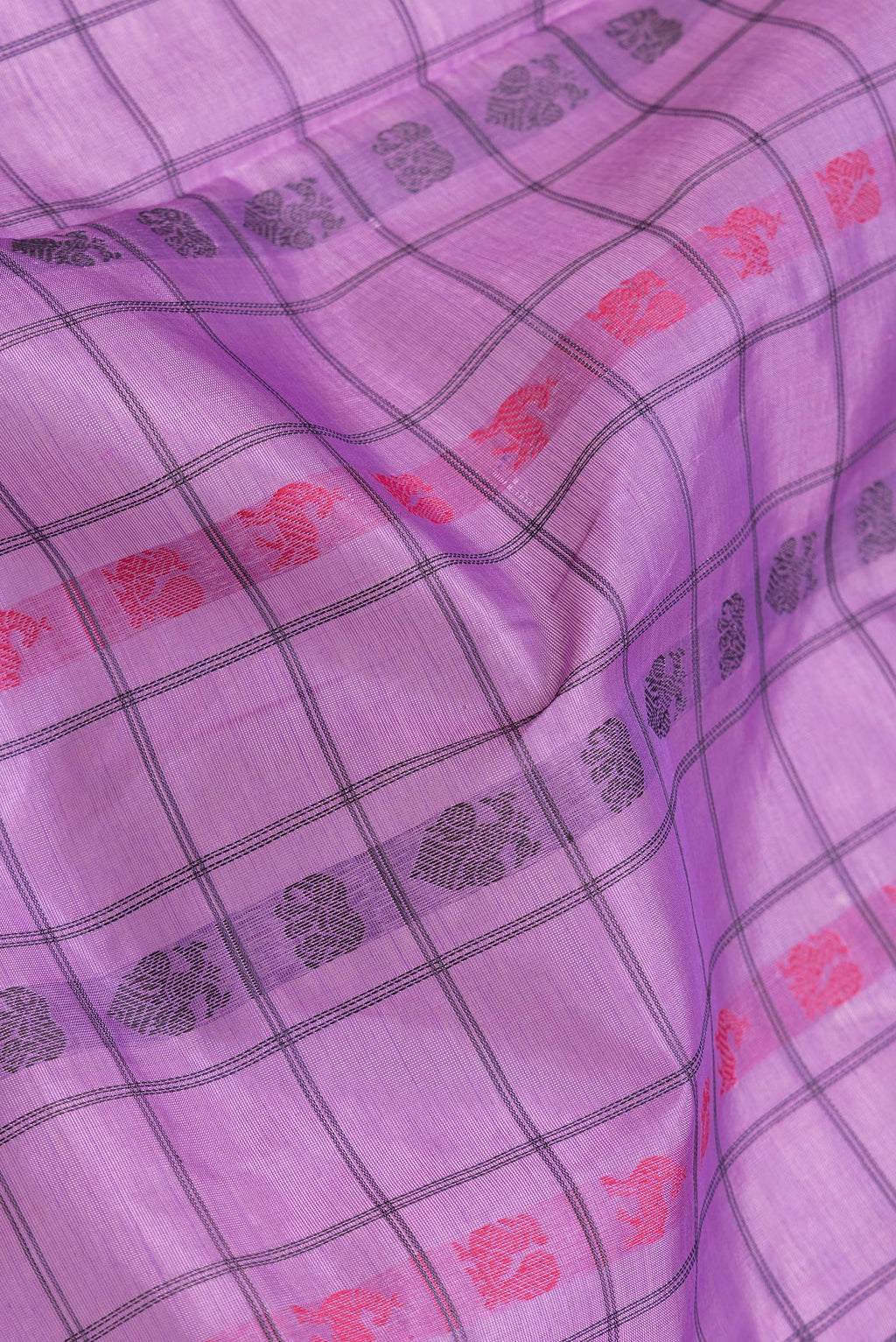 Close up of Lavender Dual Tone Silk Cotton Saree with Thread Butta on the body and Zari Border.  displaying folds