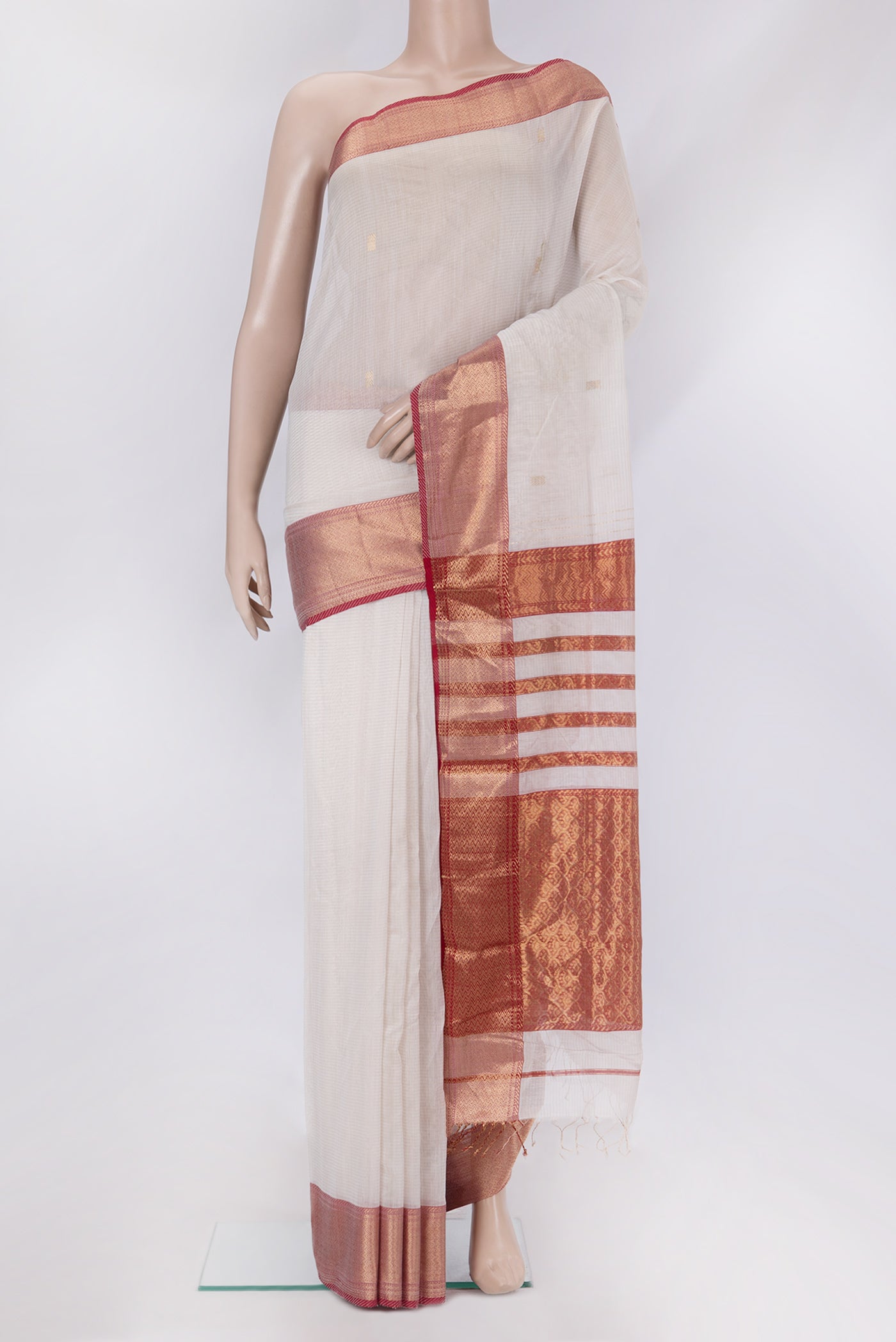 Off White Maheshwari Silk Cotton Saree with Zari Butta on the body and Zari Border.  displayed on a mannequin