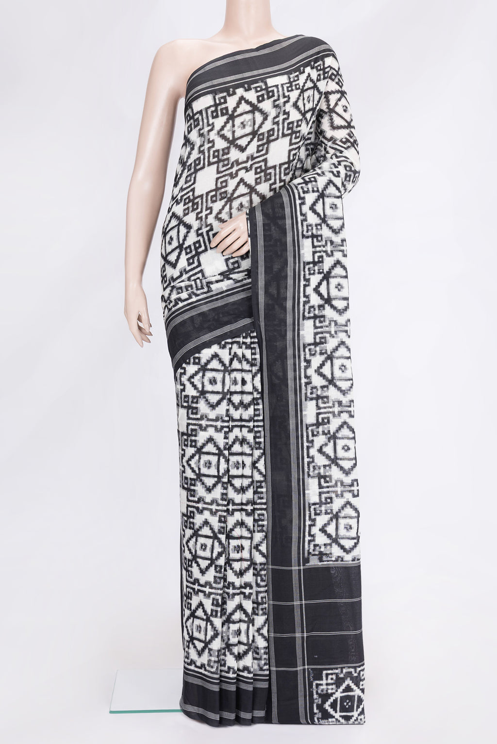 Black and White Color Double Ikat Saree with Ikat Print on the body and Thread Border.  displayed on a mannequin