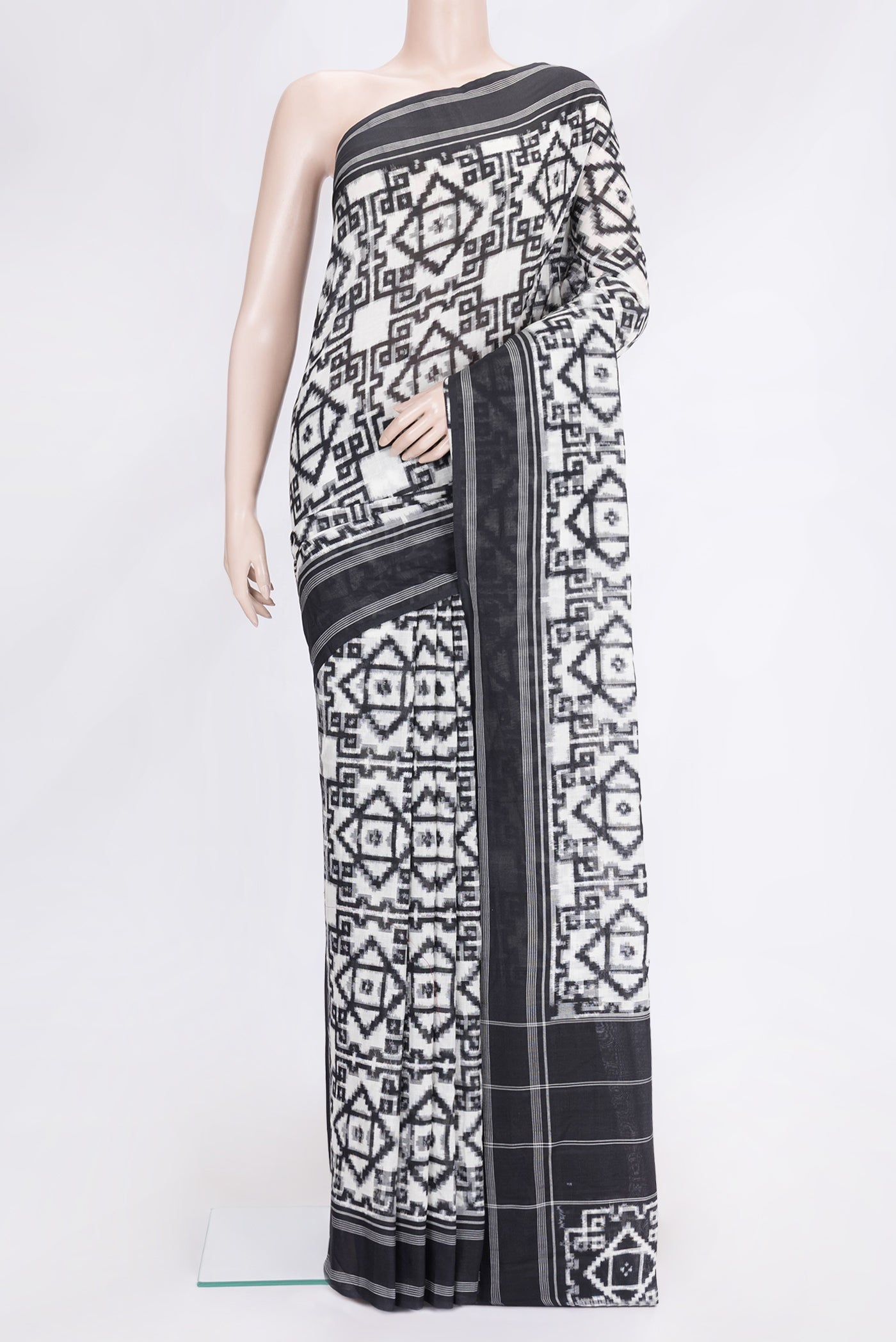 Black and White Color Double Ikat Saree with Ikat Print on the body and Thread Border.  displayed on a mannequin