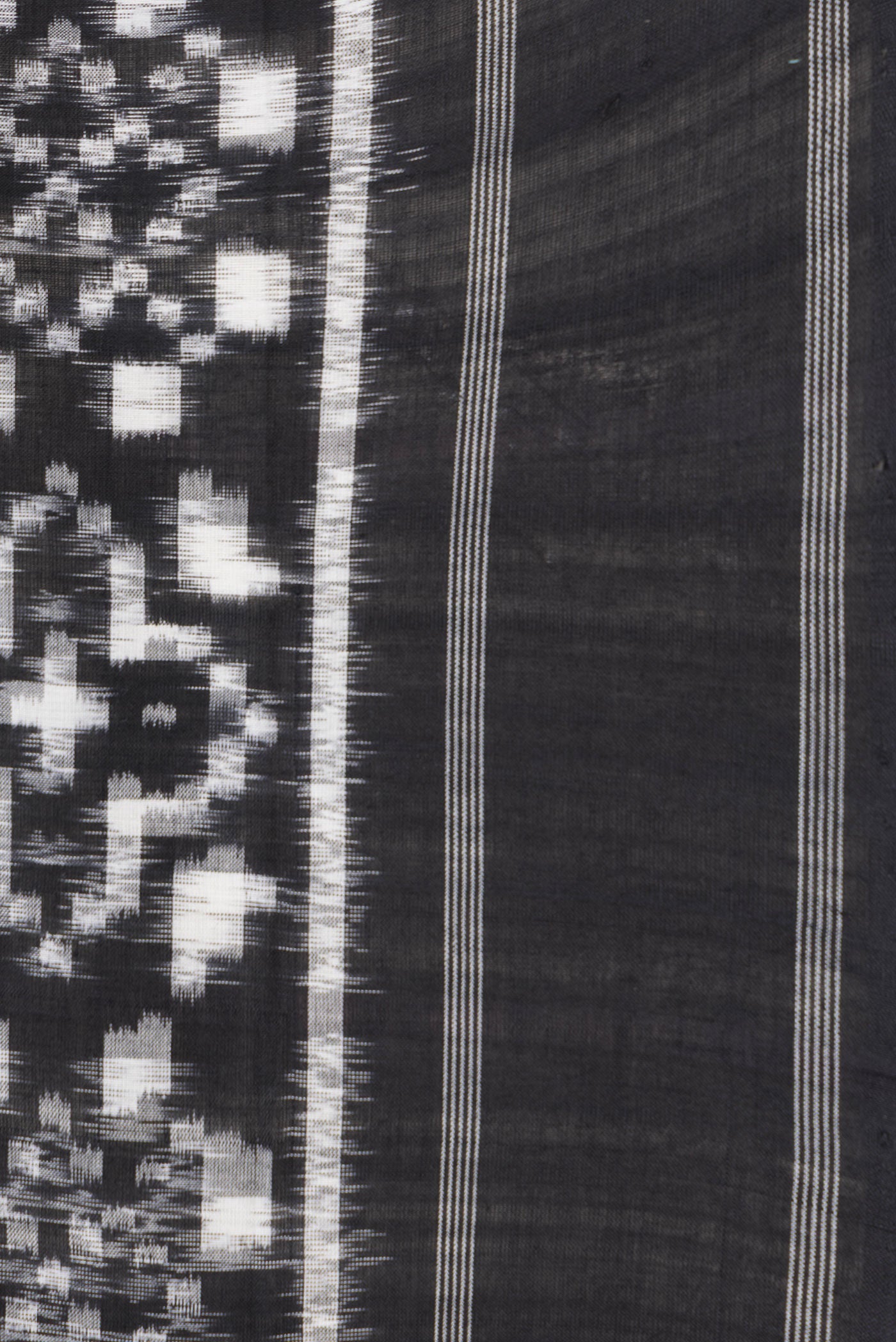 Border image of Black Dual Tone Double Ikat Saree with Ikat Print on the body and Thread Border. 