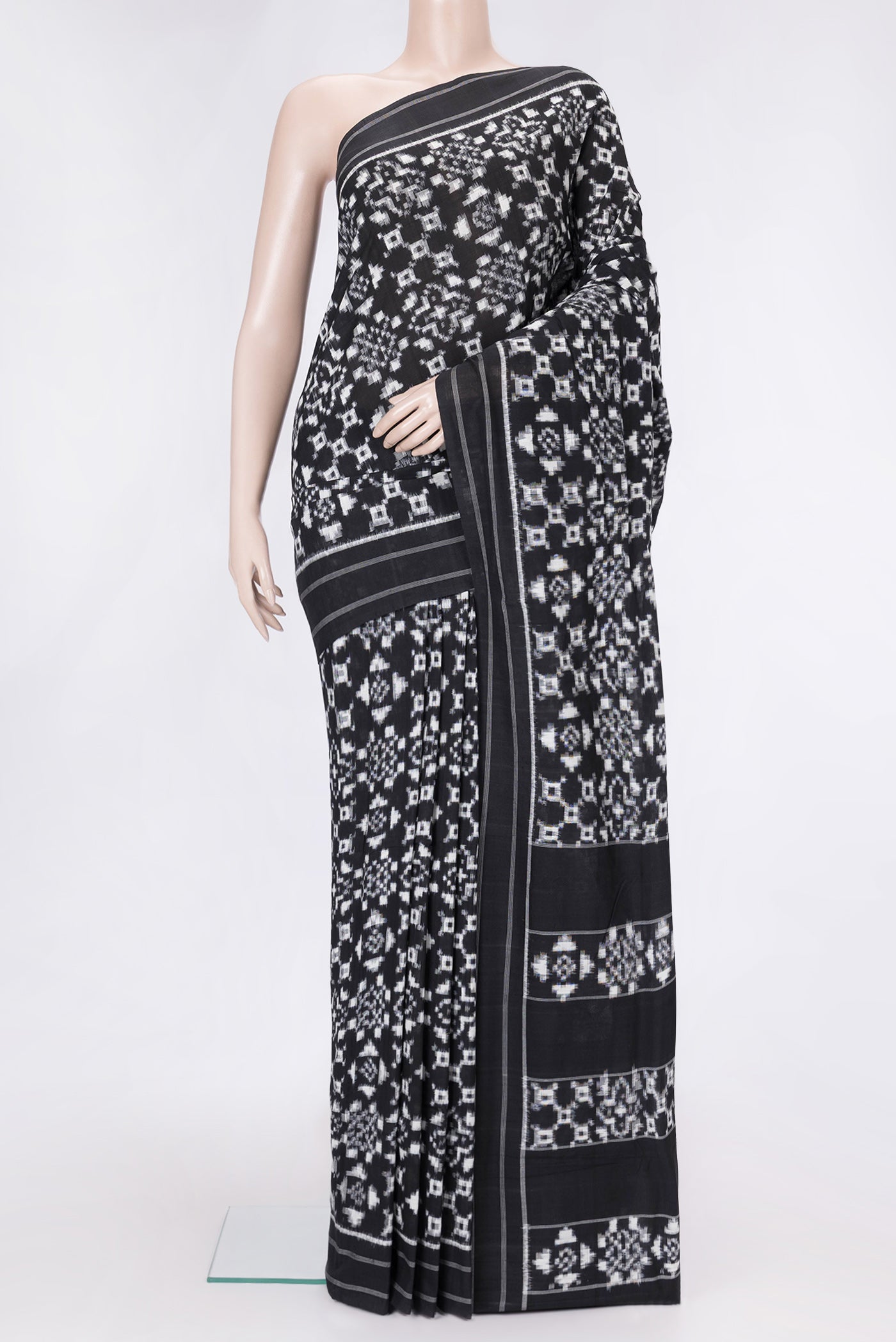Black Dual Tone Double Ikat Saree with Ikat Print on the body and Thread Border.  displayed on a mannequin