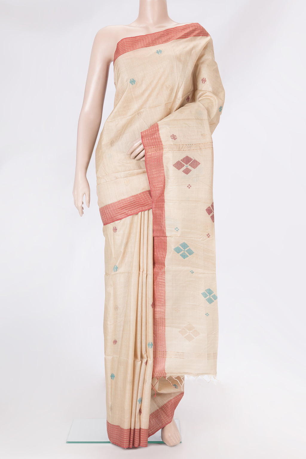 Beige Tussar Silk Saree with Thread Butta on the body and Plain Border.  displayed on a mannequin