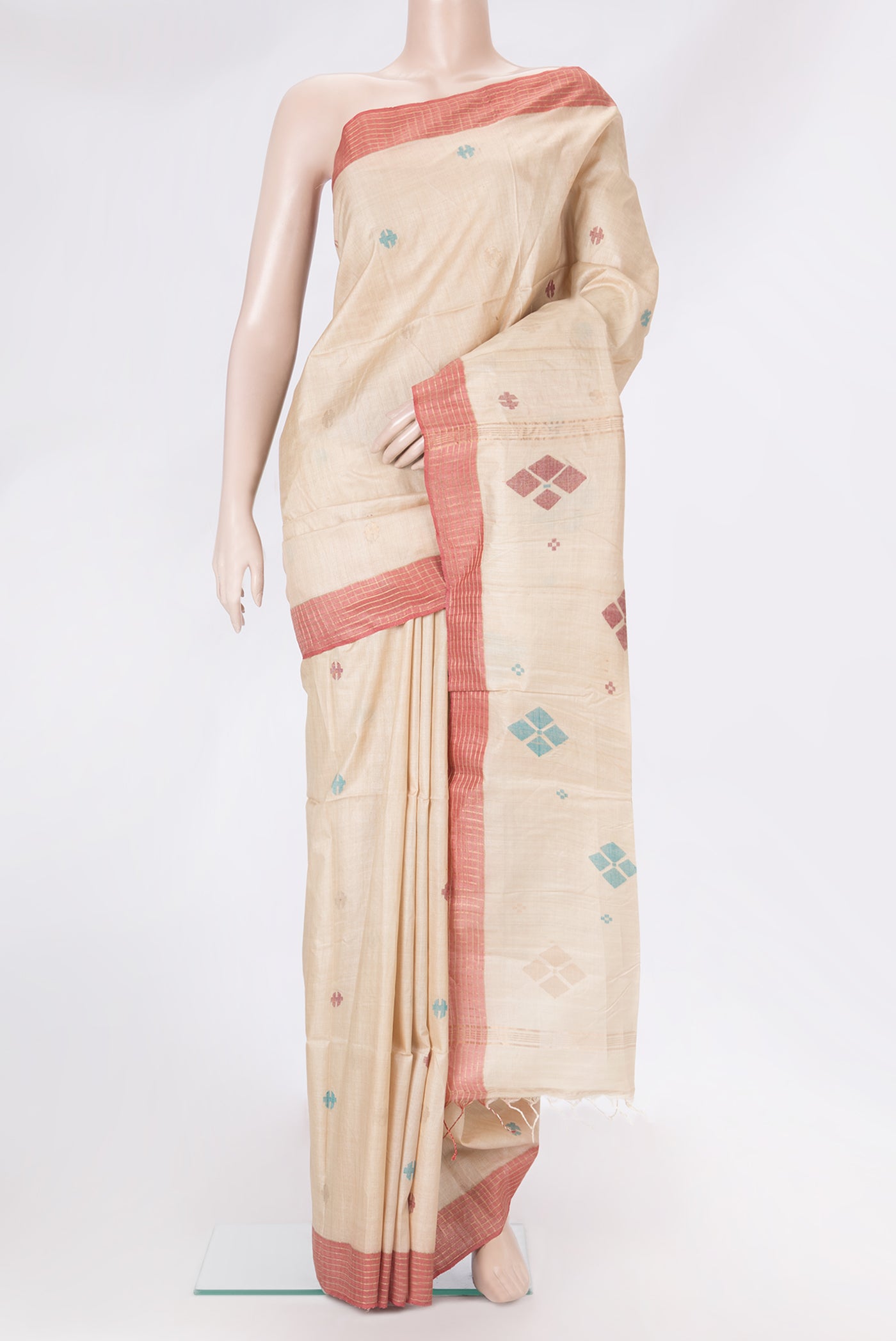 Beige Tussar Silk Saree with Thread Butta on the body and Plain Border.  displayed on a mannequin