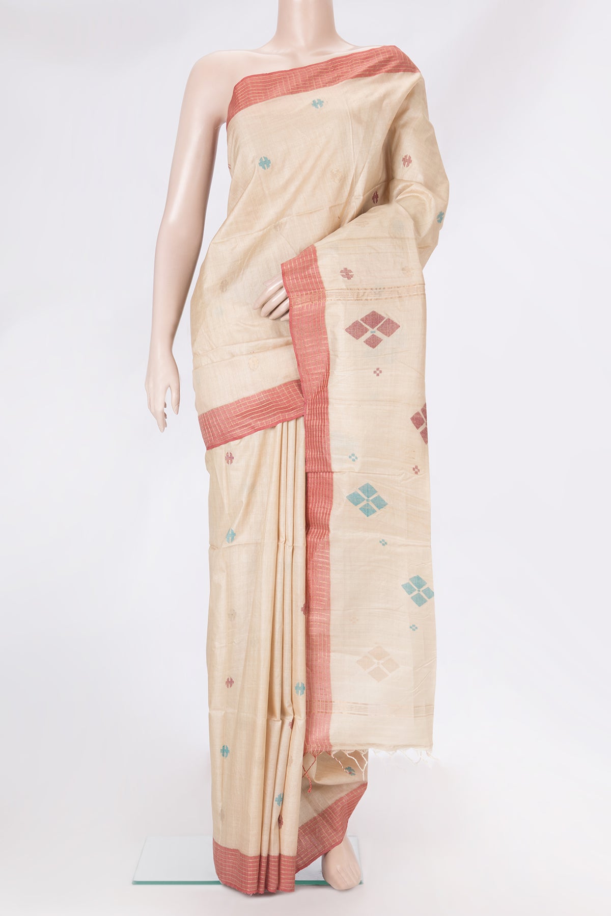 Beige Tussar Silk Saree with Thread Butta on the body and Plain Border.  displayed on a mannequin