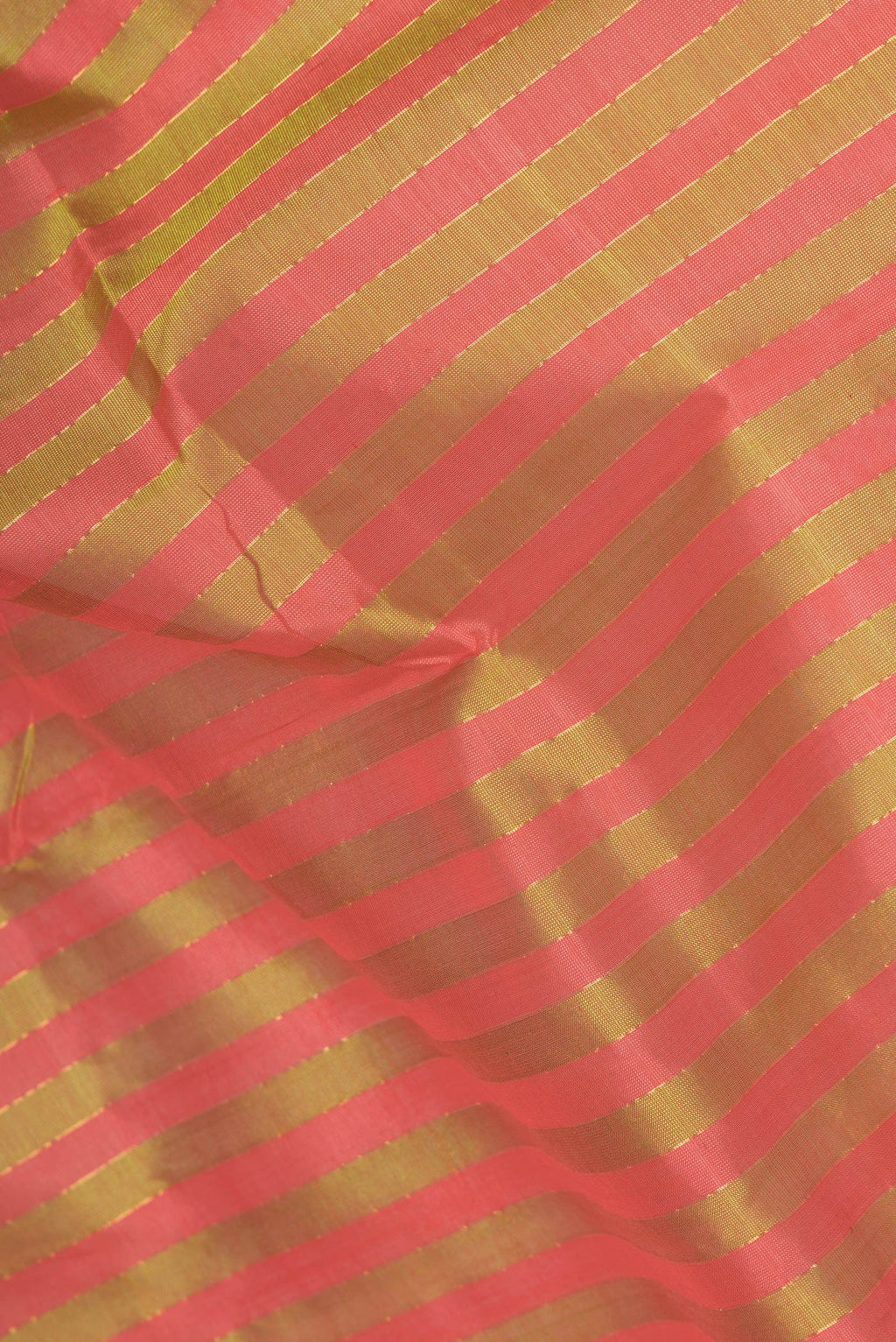 Close up of Green and Pink Color Silk Cotton Saree with Stripes on the body and Zari Border.  displaying folds