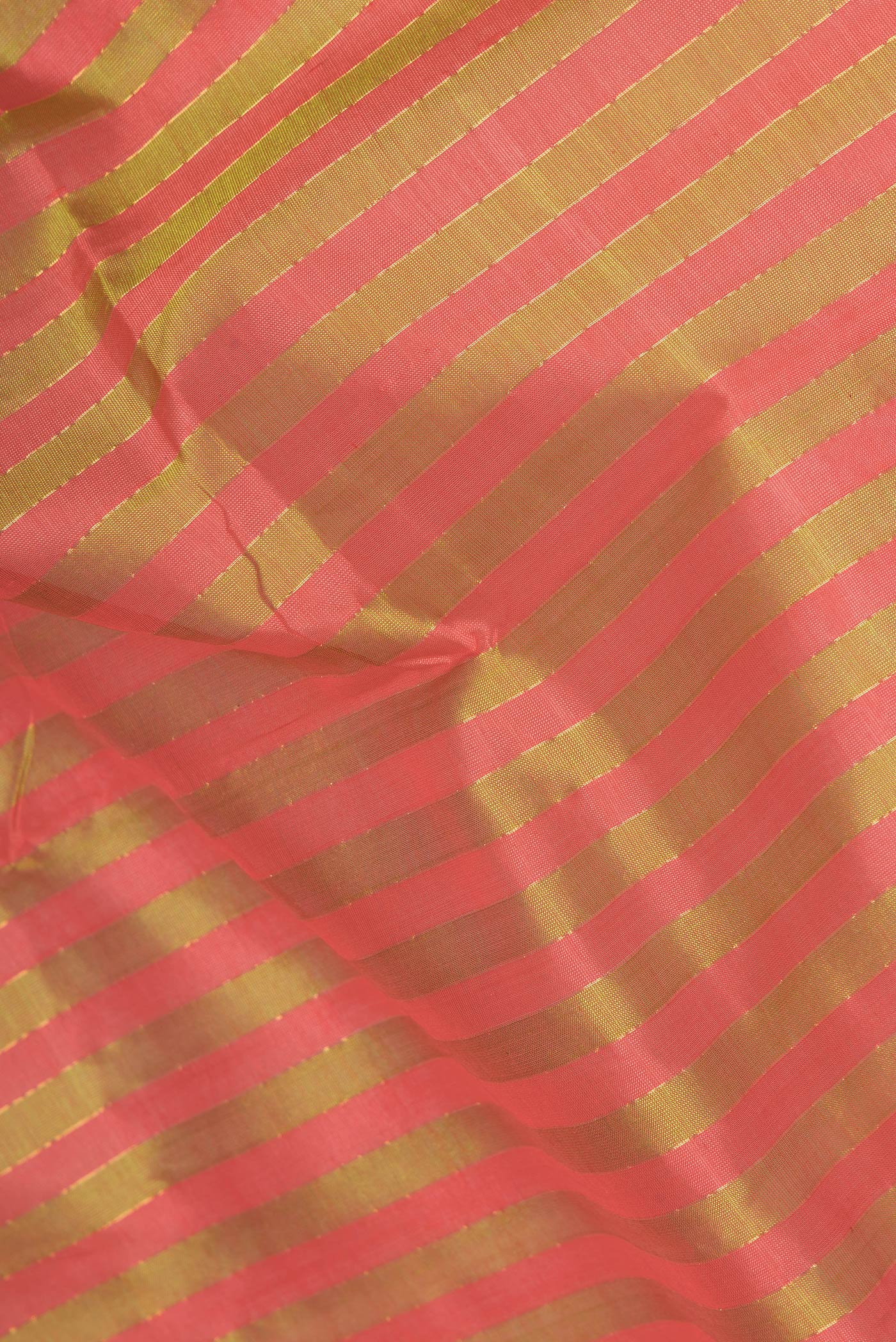 Close up of Green and Pink Color Silk Cotton Saree with Stripes on the body and Zari Border.  displaying folds