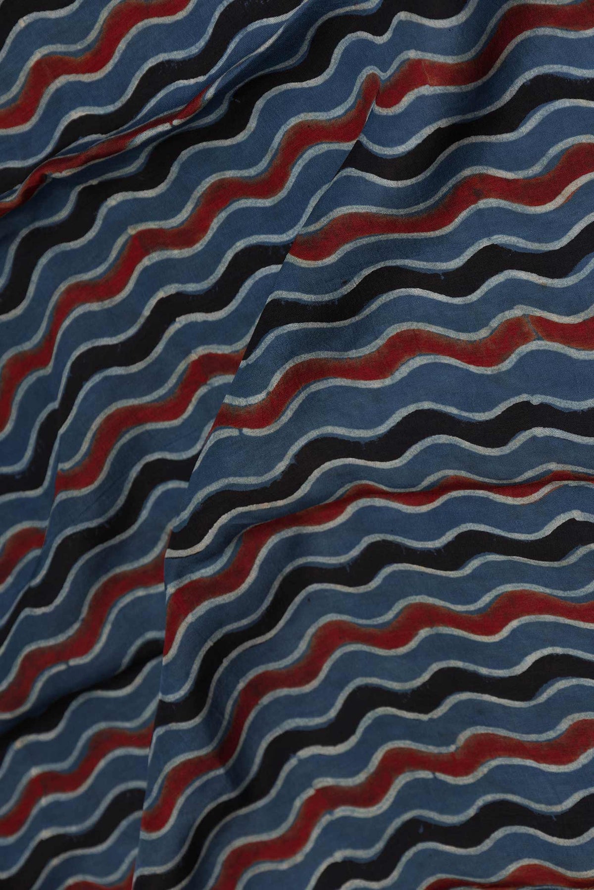 Close up of Blue Dual Tone Tussar Silk Saree with Printed design on the body and Zari Border displaying folds