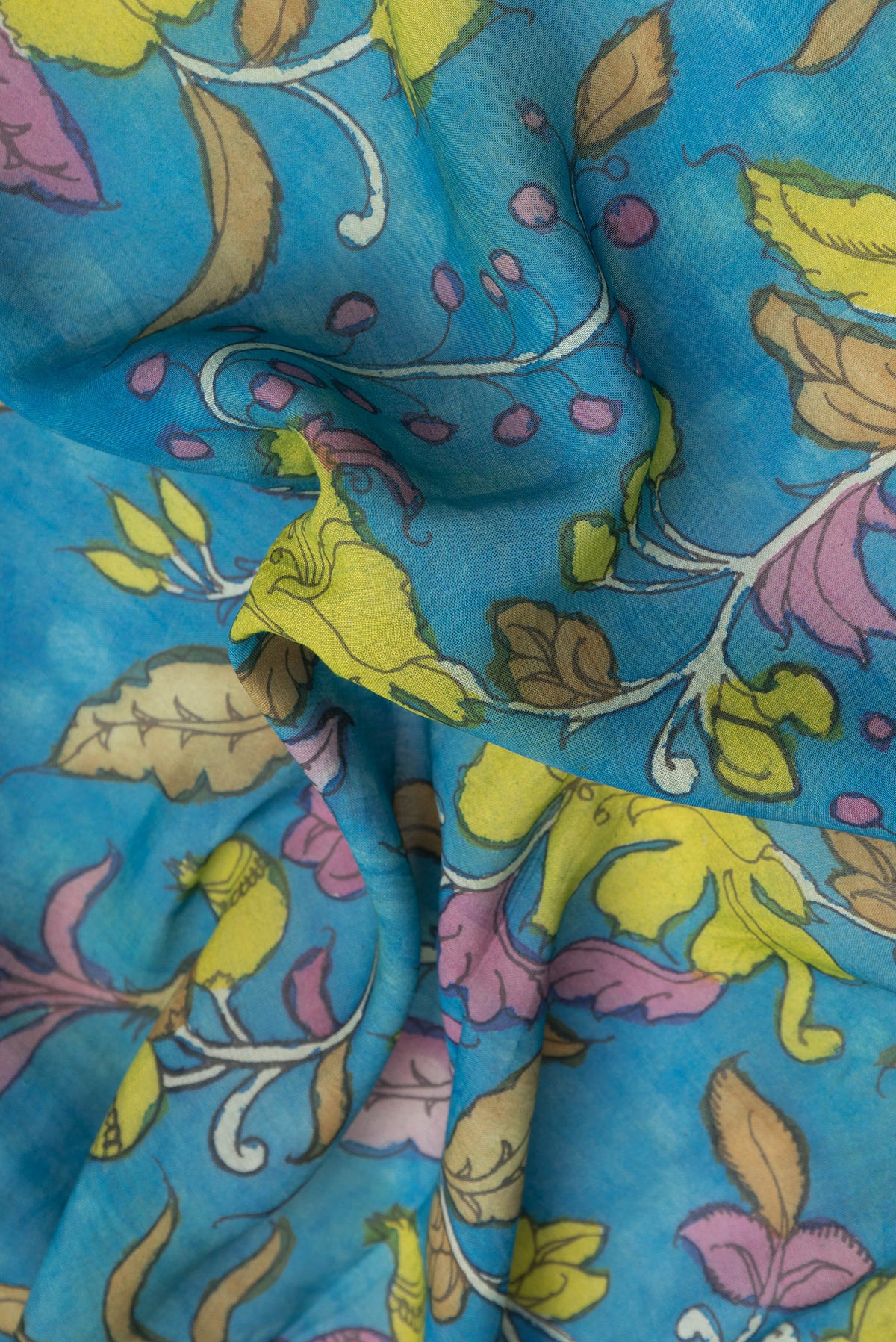 Close up of Sky Blue Dual Tone Tussar Silk Saree with kalamkari Print on the body and Zari Border.  displaying folds