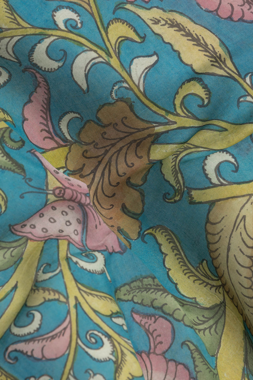 Close up of Sky Blue Tussar Silk Saree with kalamkari Print on the body and Zari Border.  displaying folds