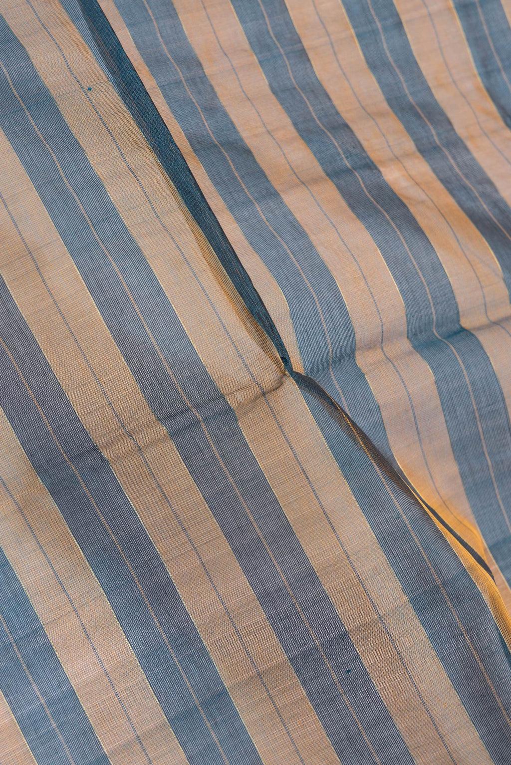 Close up of Peacock Blue Dual Tone Silk Cotton Saree with Stripes on the body and Zari Border.  displaying folds
