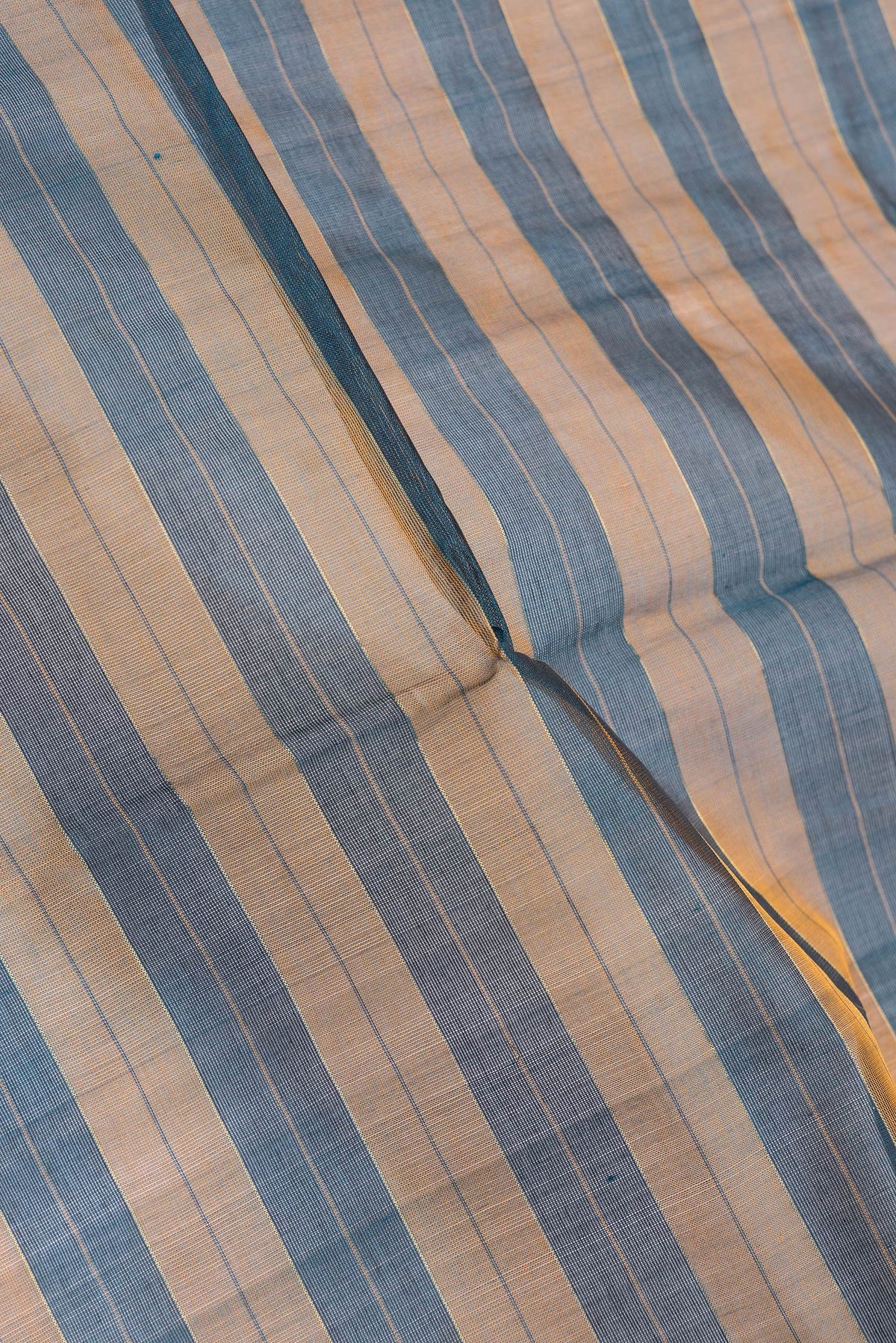 Close up of Peacock Blue Dual Tone Silk Cotton Saree with Stripes on the body and Zari Border.  displaying folds