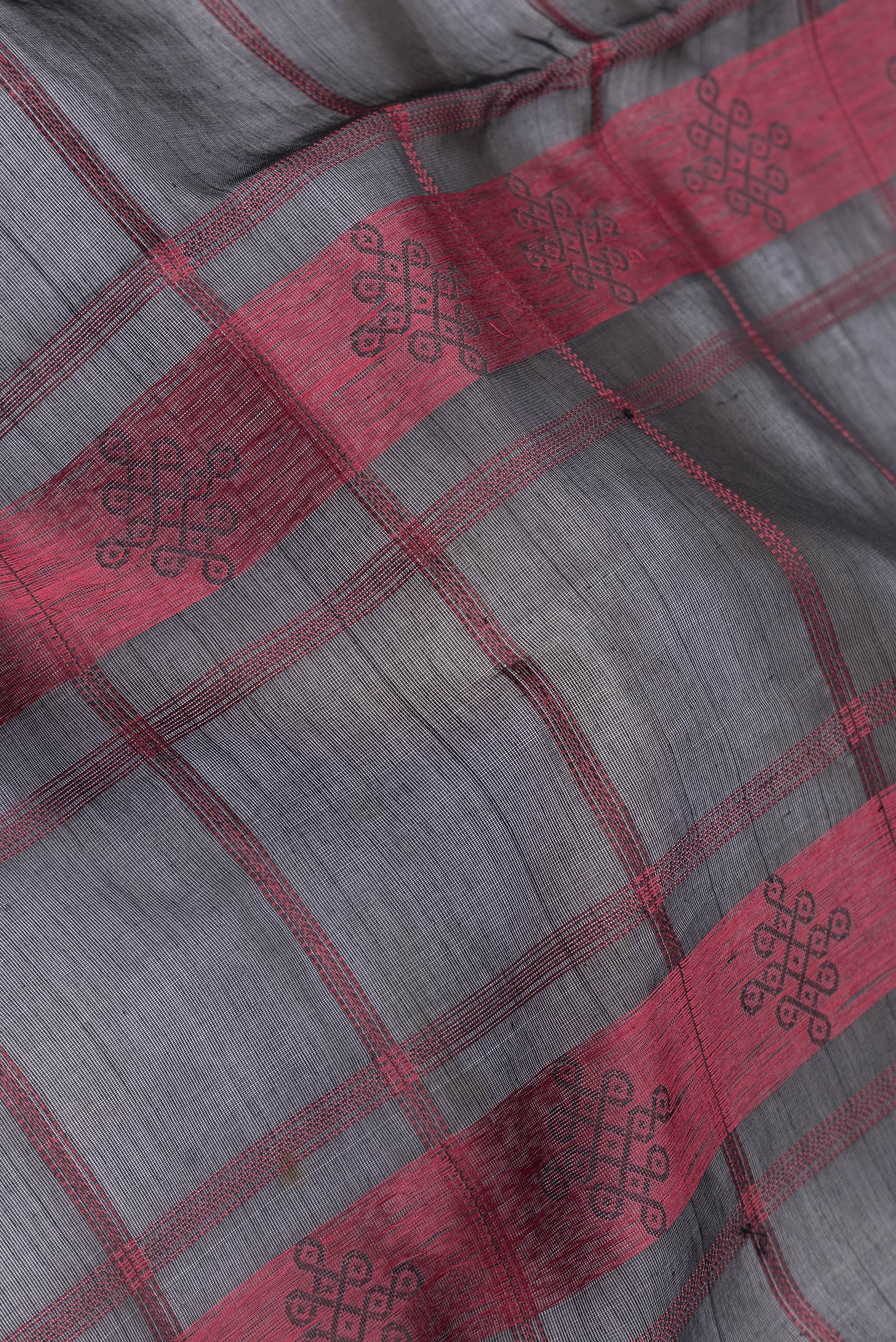 Close up of Black Dual Tone Silk Cotton Saree with Thread Butta on the body and Zari Border.  displaying folds