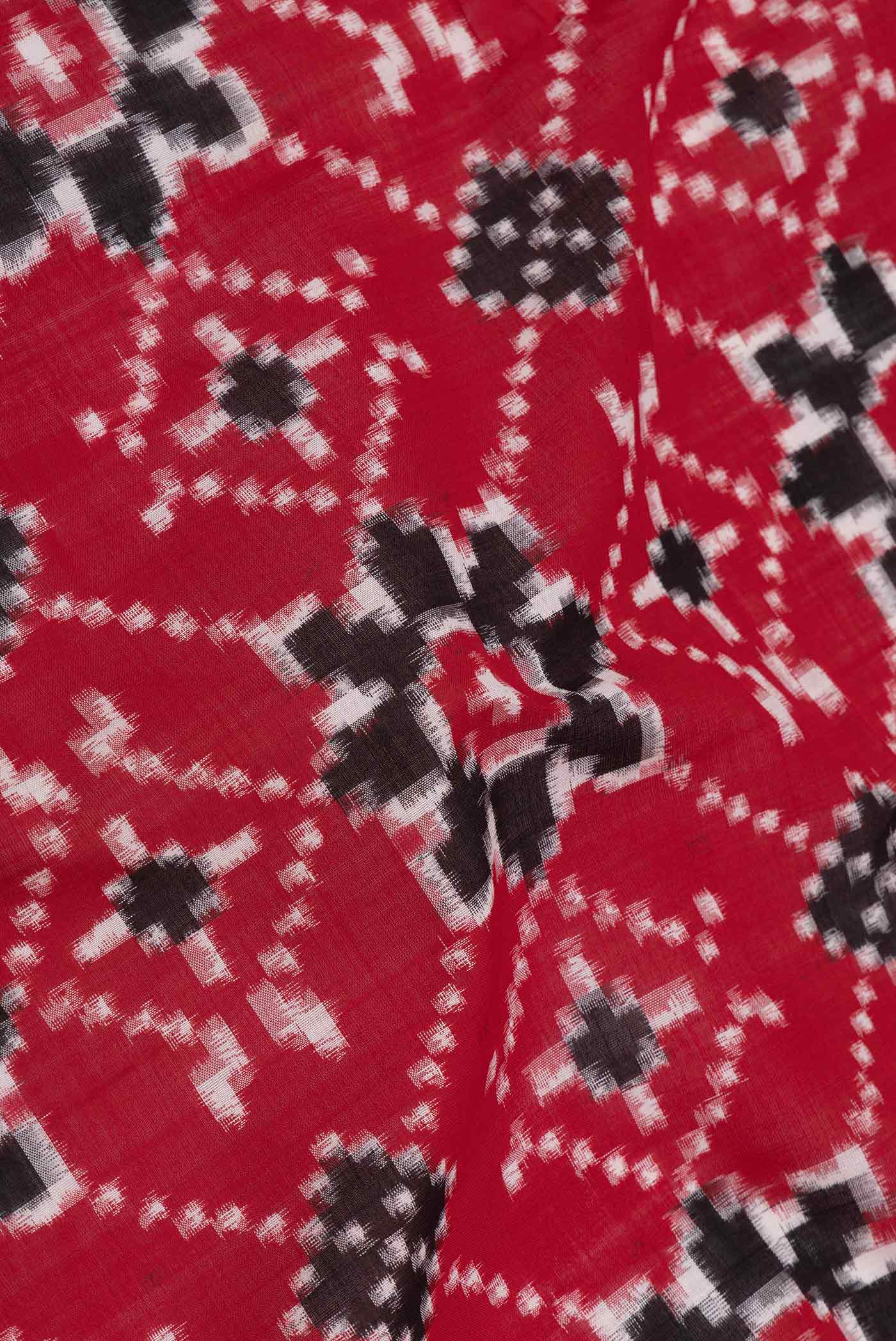 Close up of Red Dual Tone Double Ikat Saree with Ikat Print on the body and Plain Border displaying folds